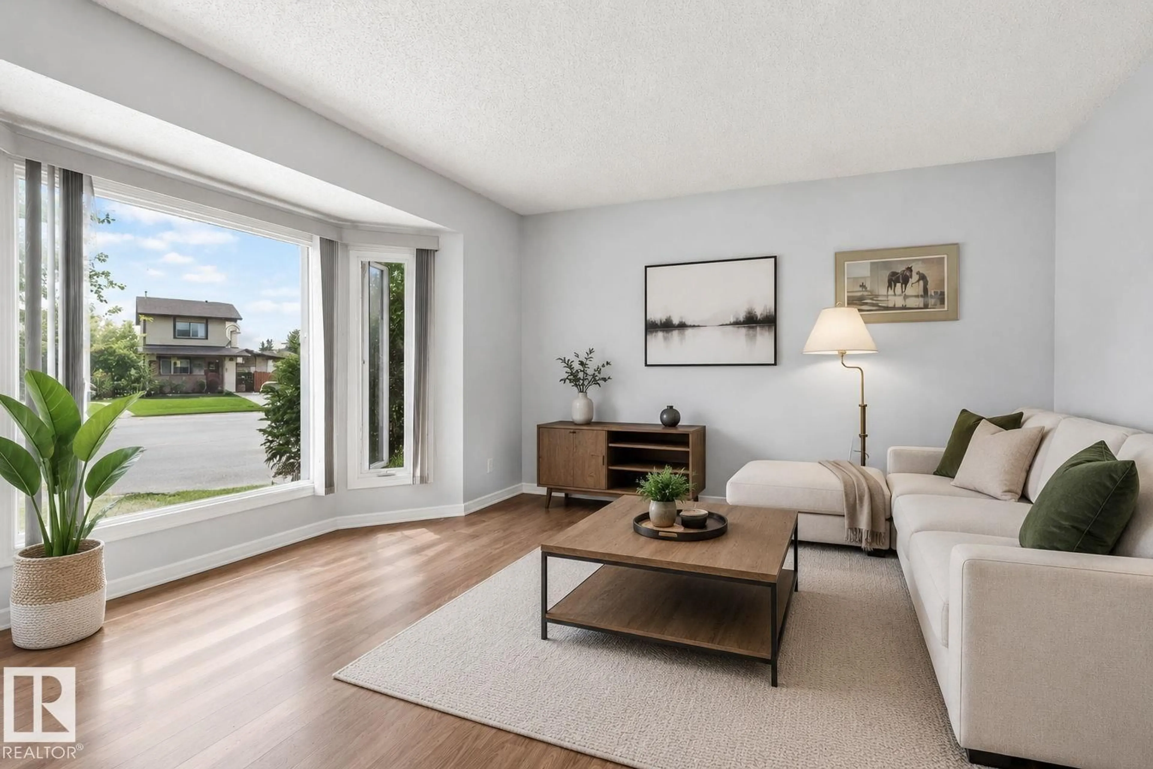 Living room with furniture, wood/laminate floor for 8316 157 AV, Edmonton Alberta T5Z2P7