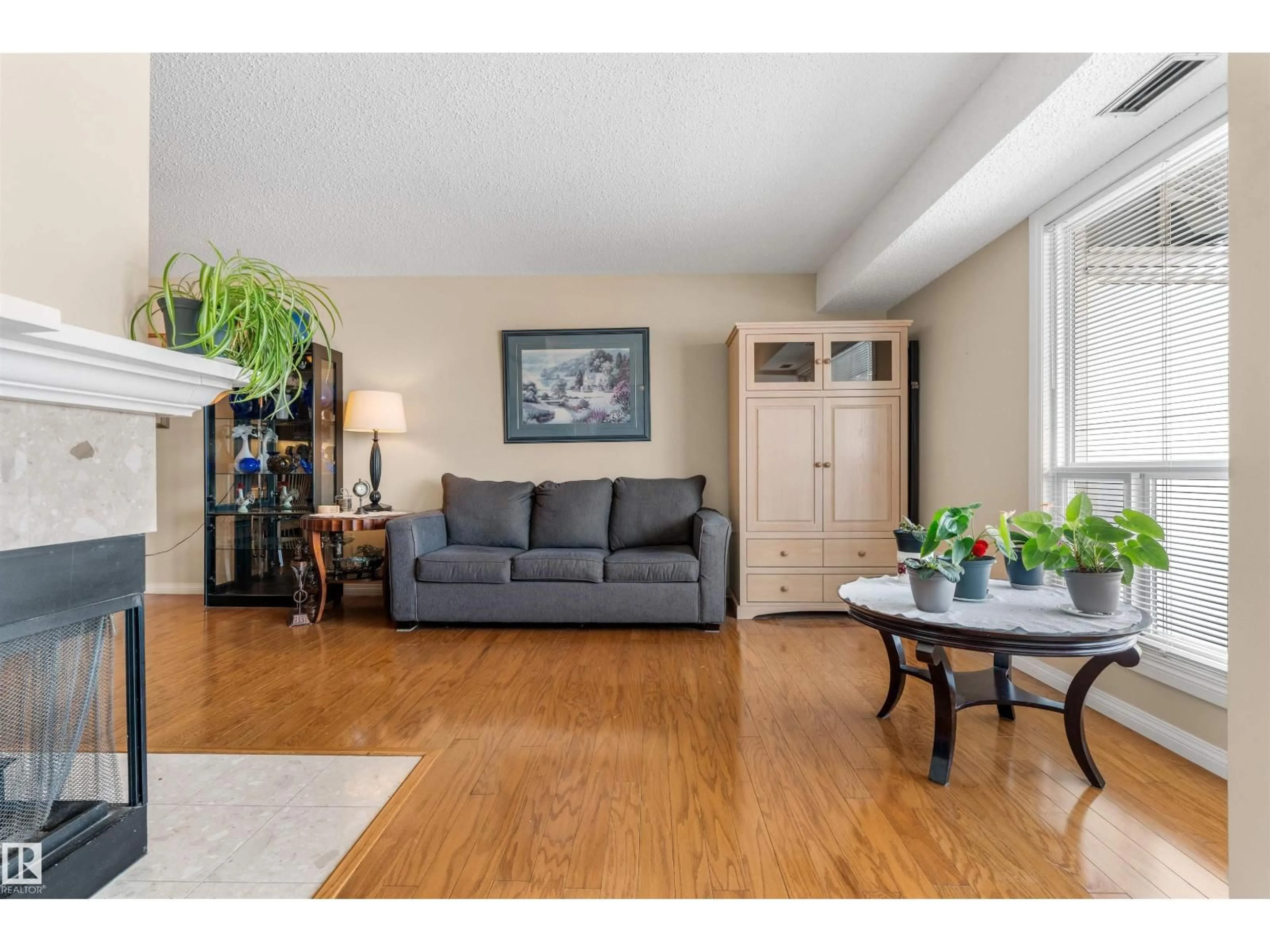 Living room with furniture, wood/laminate floor for NW - 2324 151 AV, Edmonton Alberta T5Y2L1