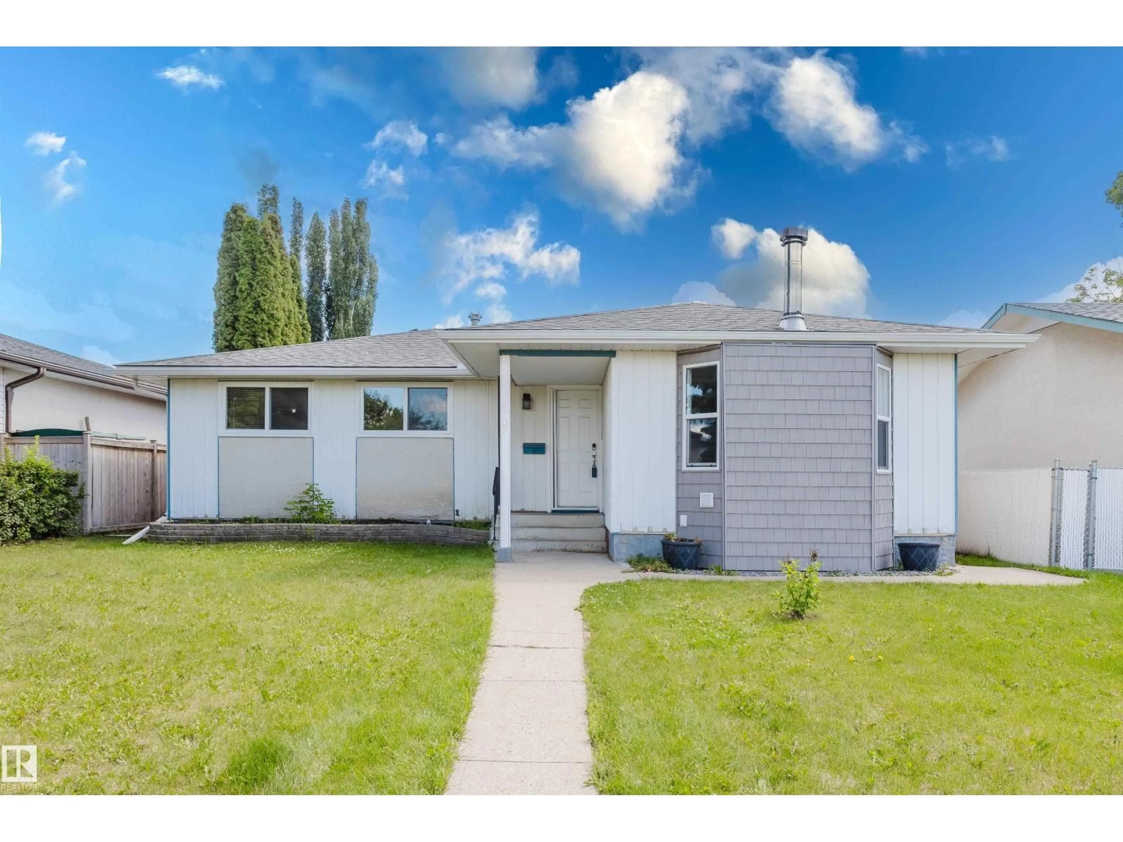 Home with vinyl exterior material, street for NW - 8707 151 AV, Edmonton Alberta T5E5Y1