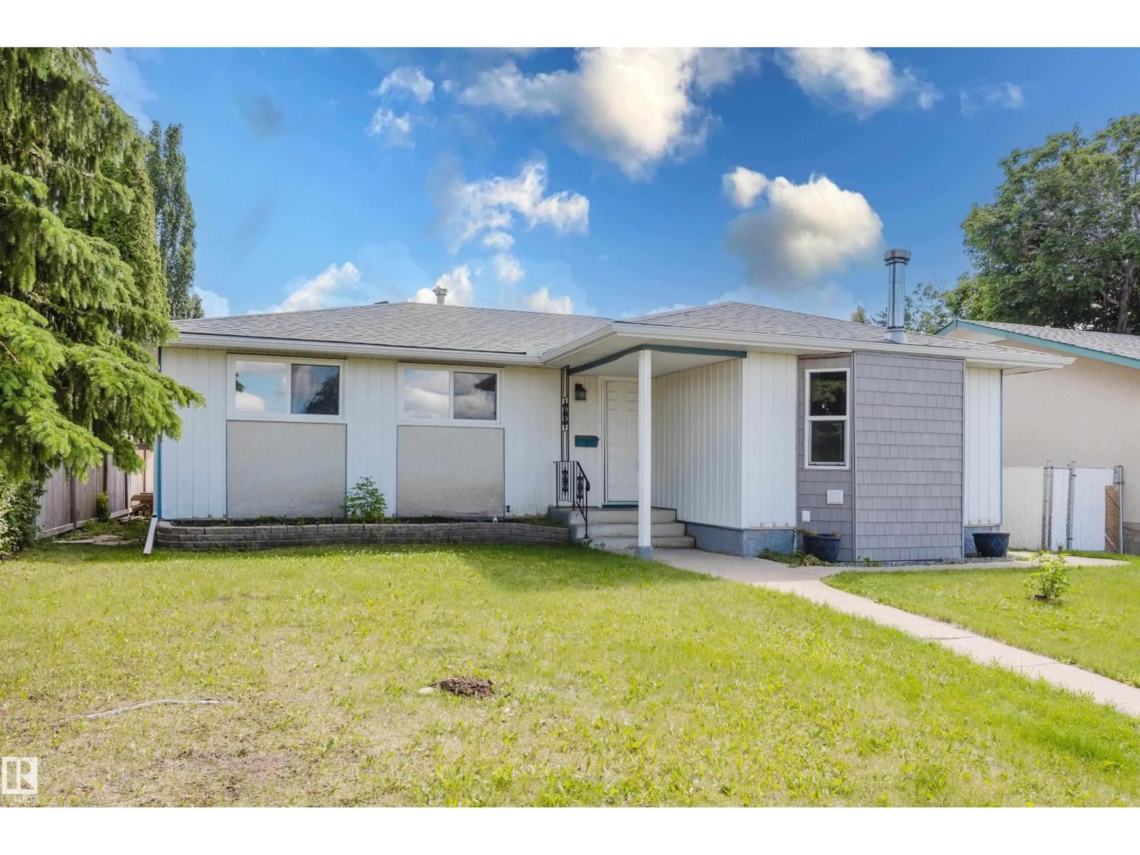 Home with vinyl exterior material, street for NW - 8707 151 AV, Edmonton Alberta T5E5Y1
