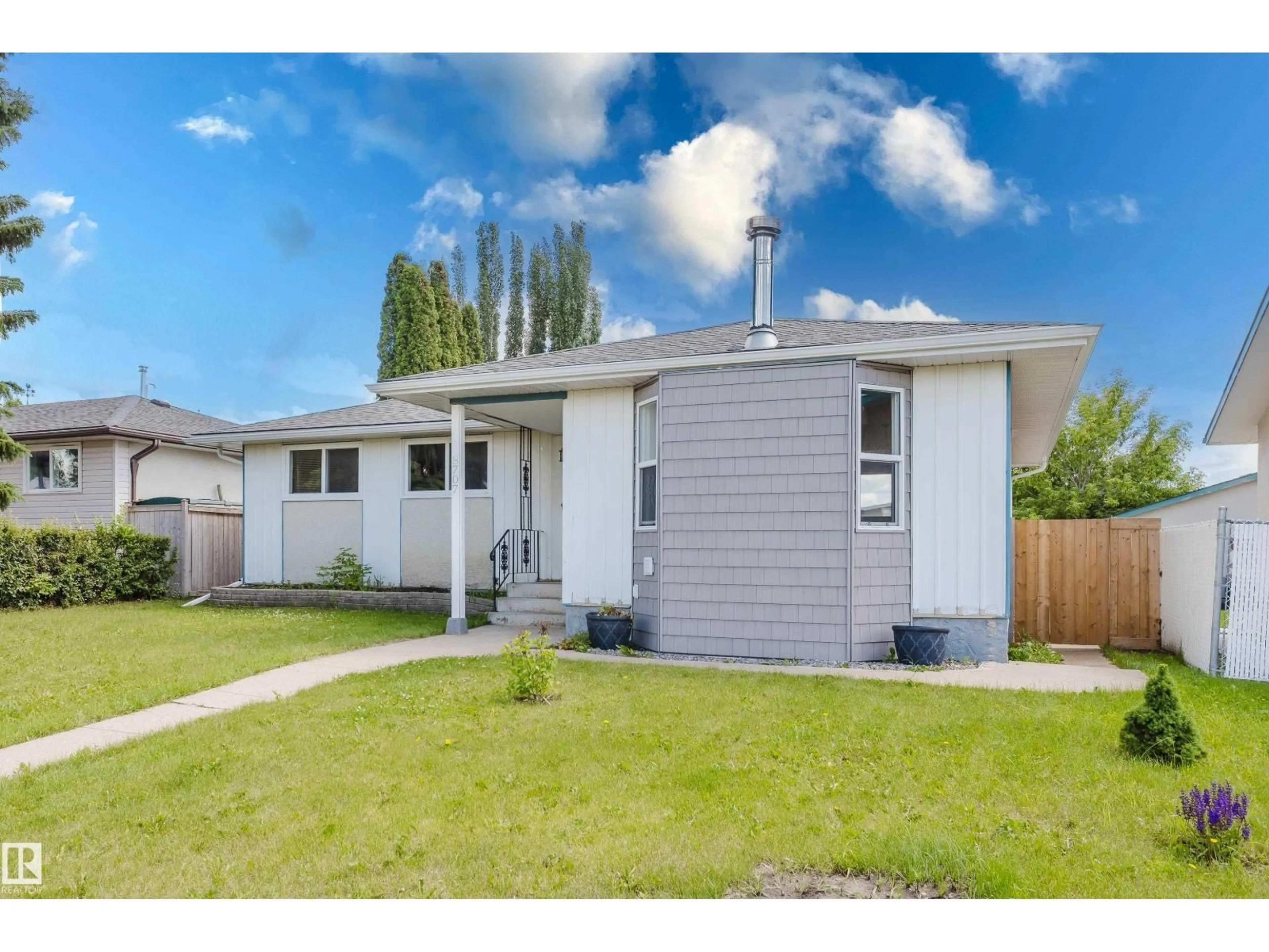Home with vinyl exterior material, street for NW - 8707 151 AV, Edmonton Alberta T5E5Y1