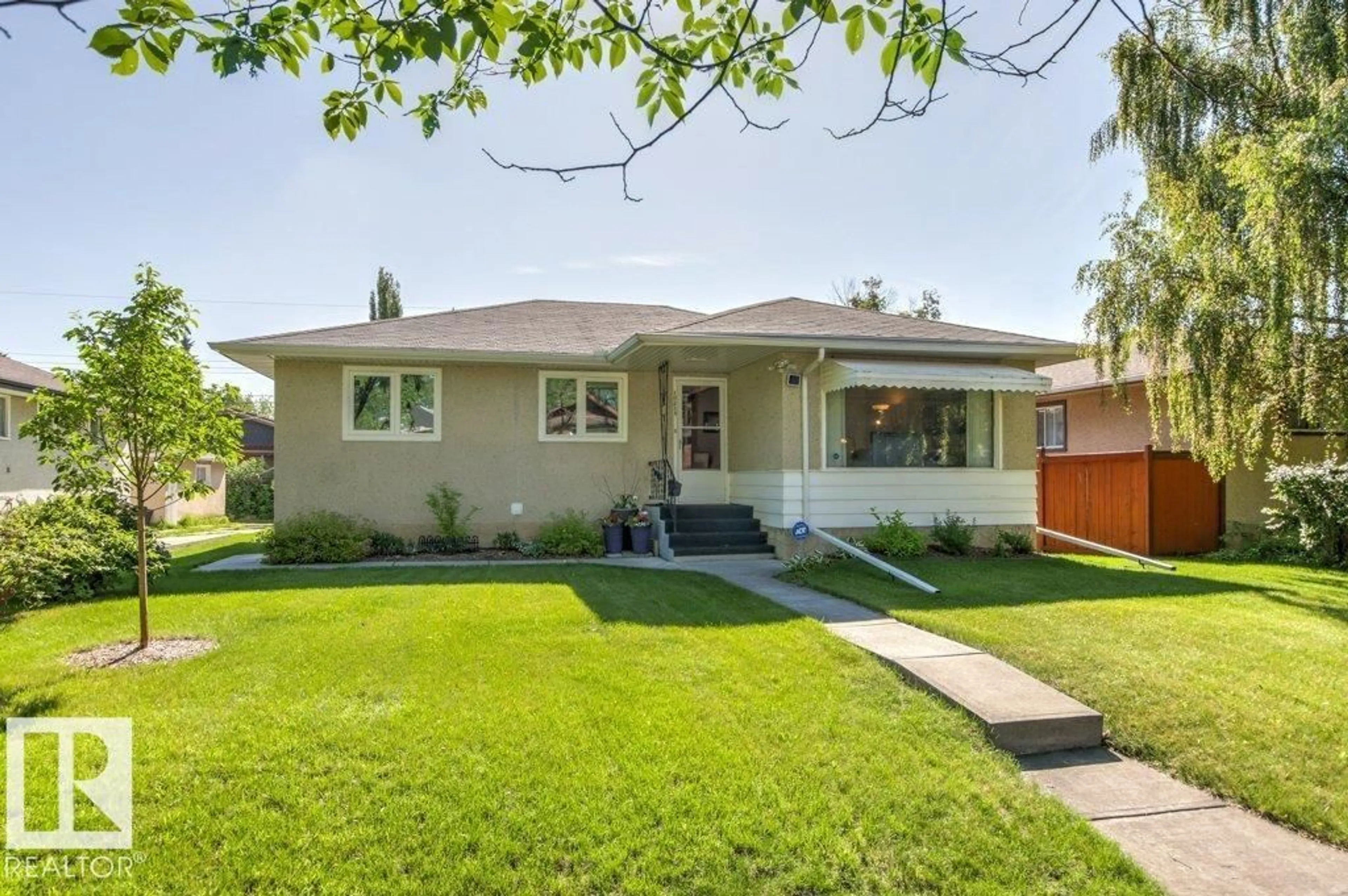 Home with vinyl exterior material, street for 10235 74 ST, Edmonton Alberta T6A2Y2