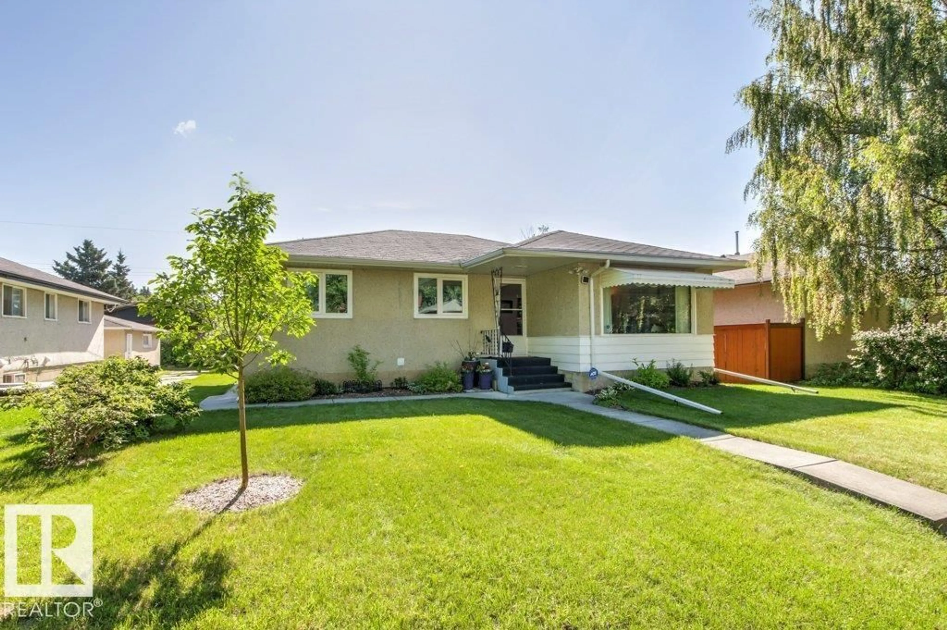 Home with vinyl exterior material, street for 10235 74 ST, Edmonton Alberta T6A2Y2