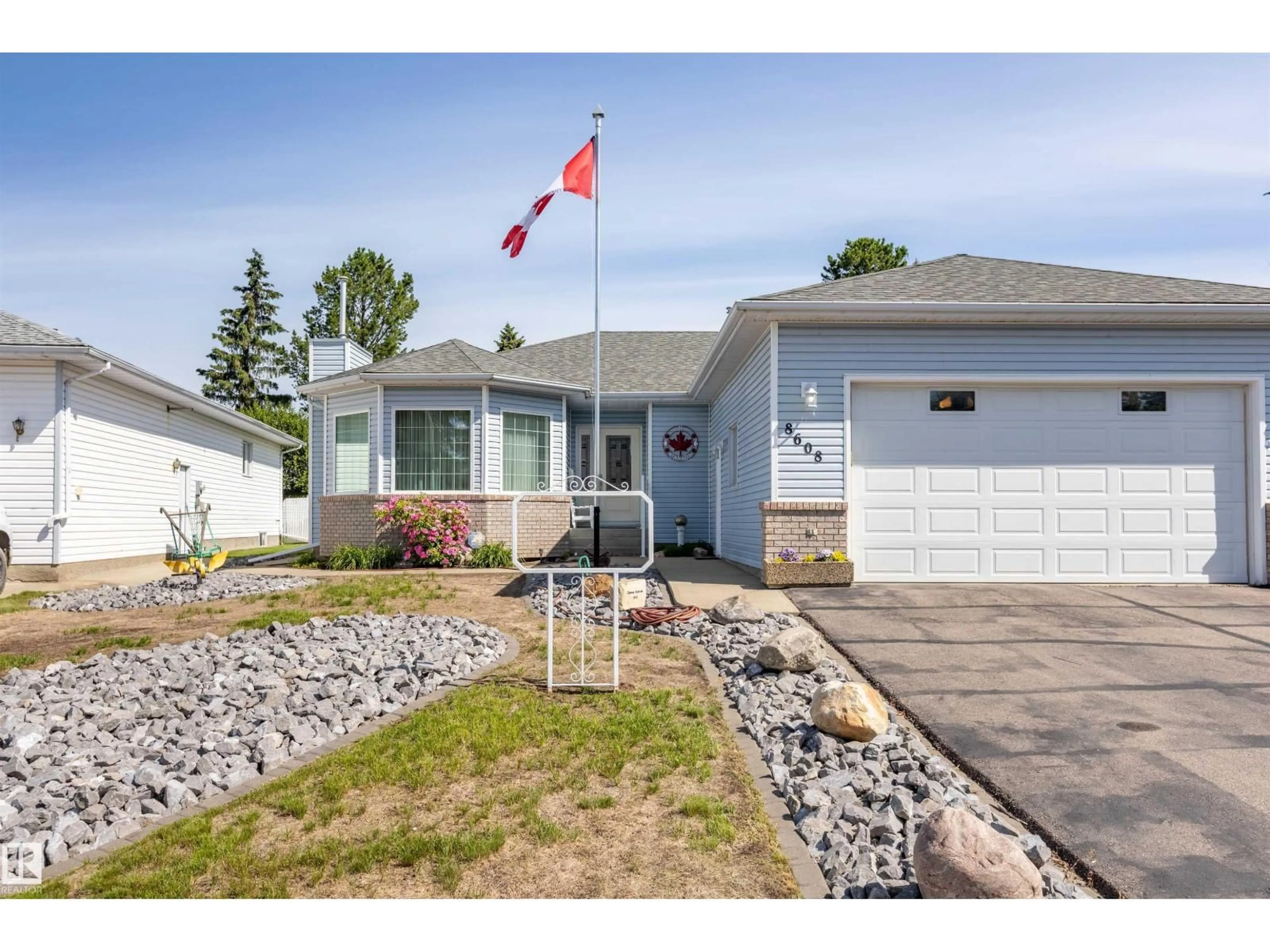 Home with vinyl exterior material, street for 8608 107 AV, Morinville Alberta T8R1C2