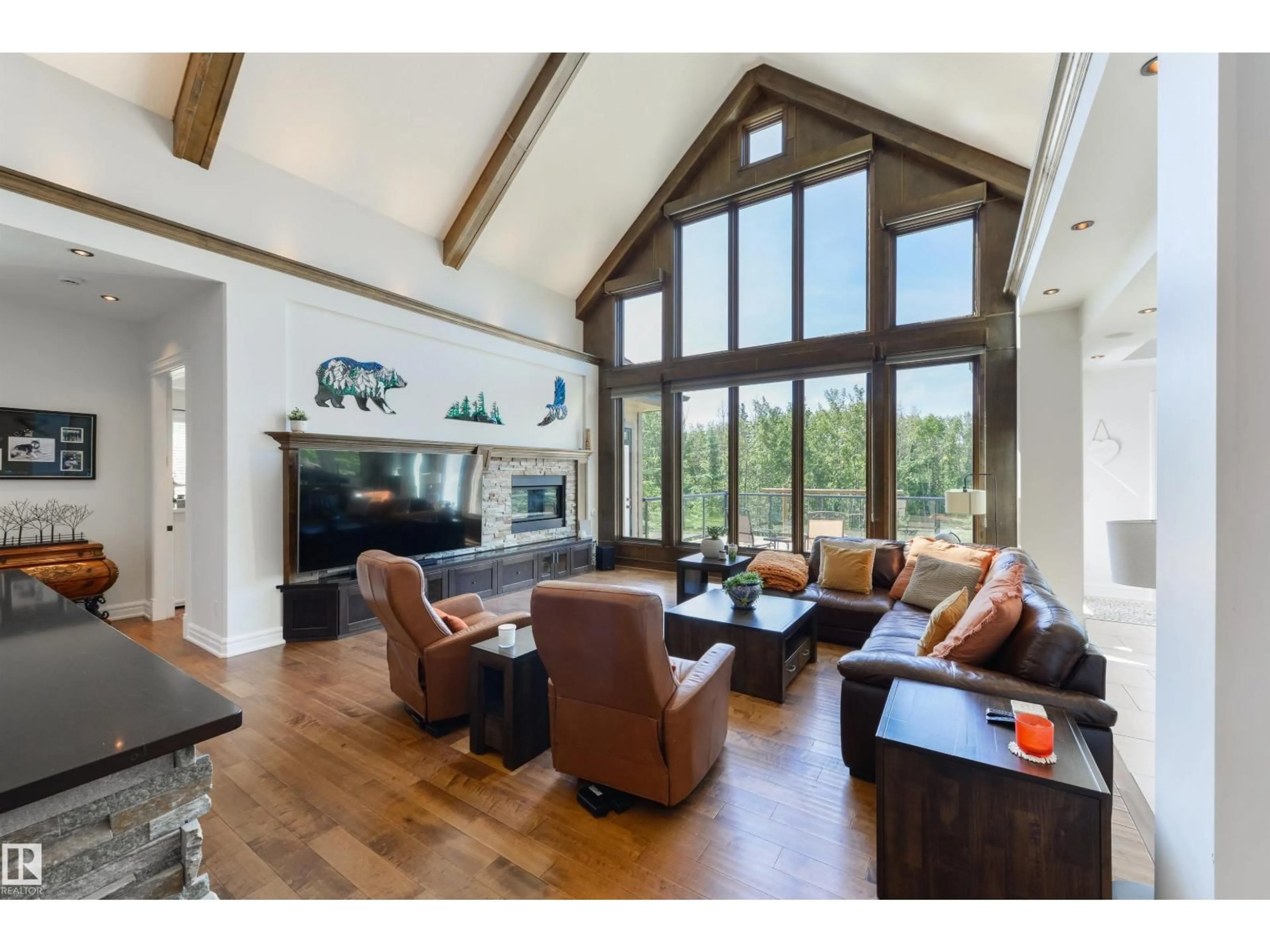 Living room with furniture, wood/laminate floor for 21 - 53412 RGE ROAD 272, Rural Parkland County Alberta T7X3N2
