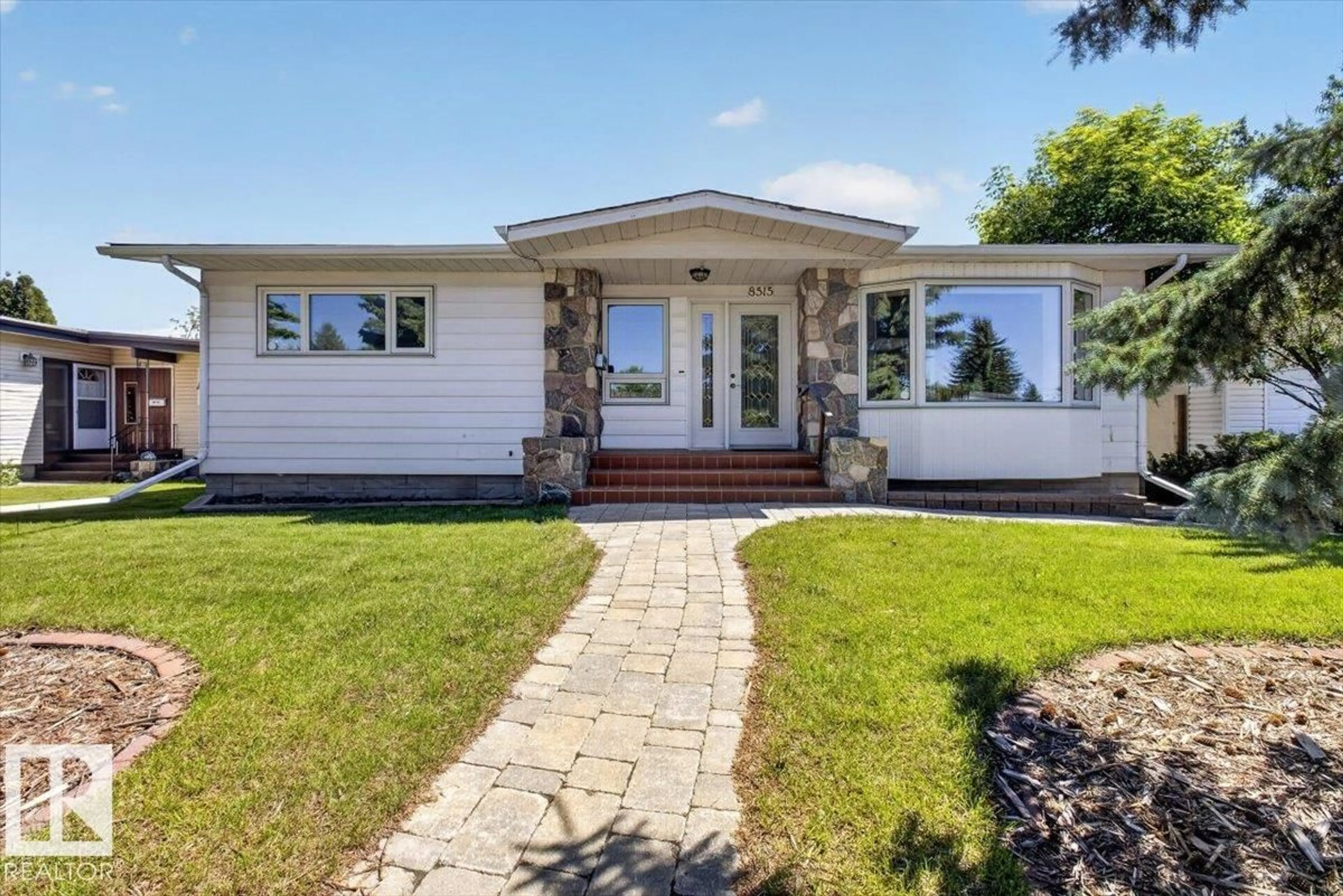Home with vinyl exterior material, street for NW - 8515 56 ST, Edmonton Alberta T6B1H8