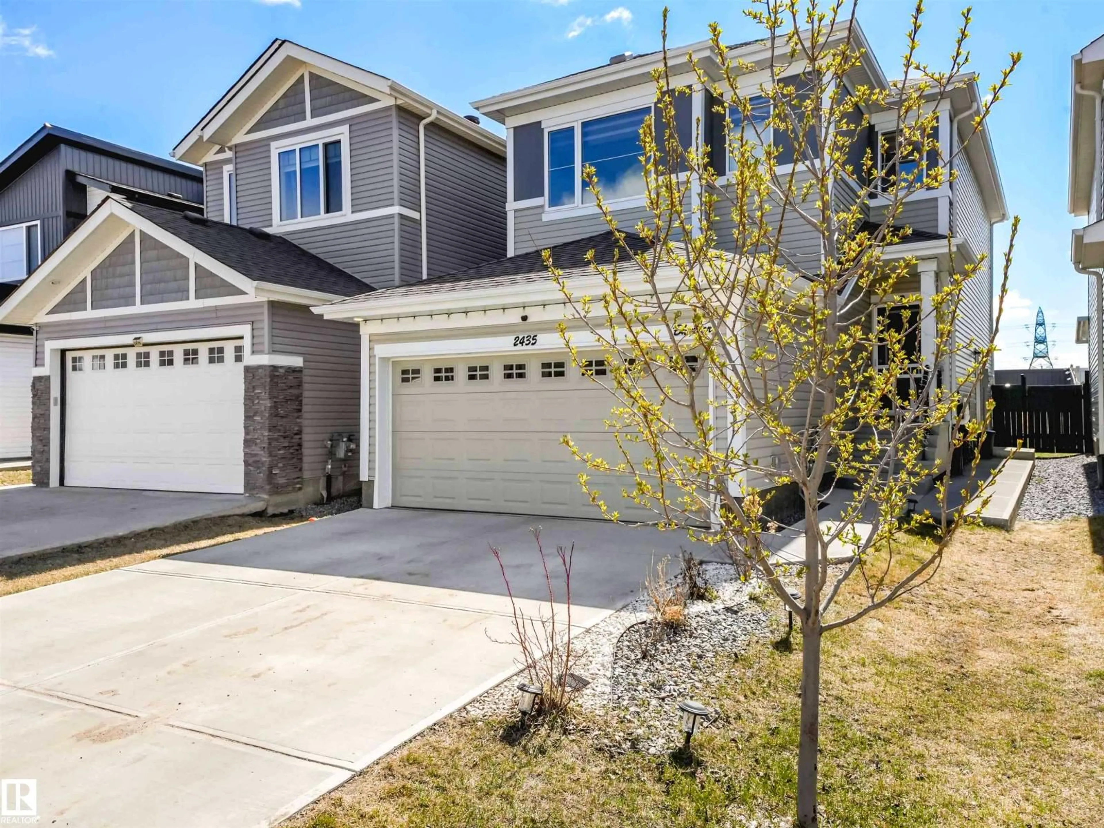 Home with vinyl exterior material, street for 2435 12 AV, Edmonton Alberta T6T2M6