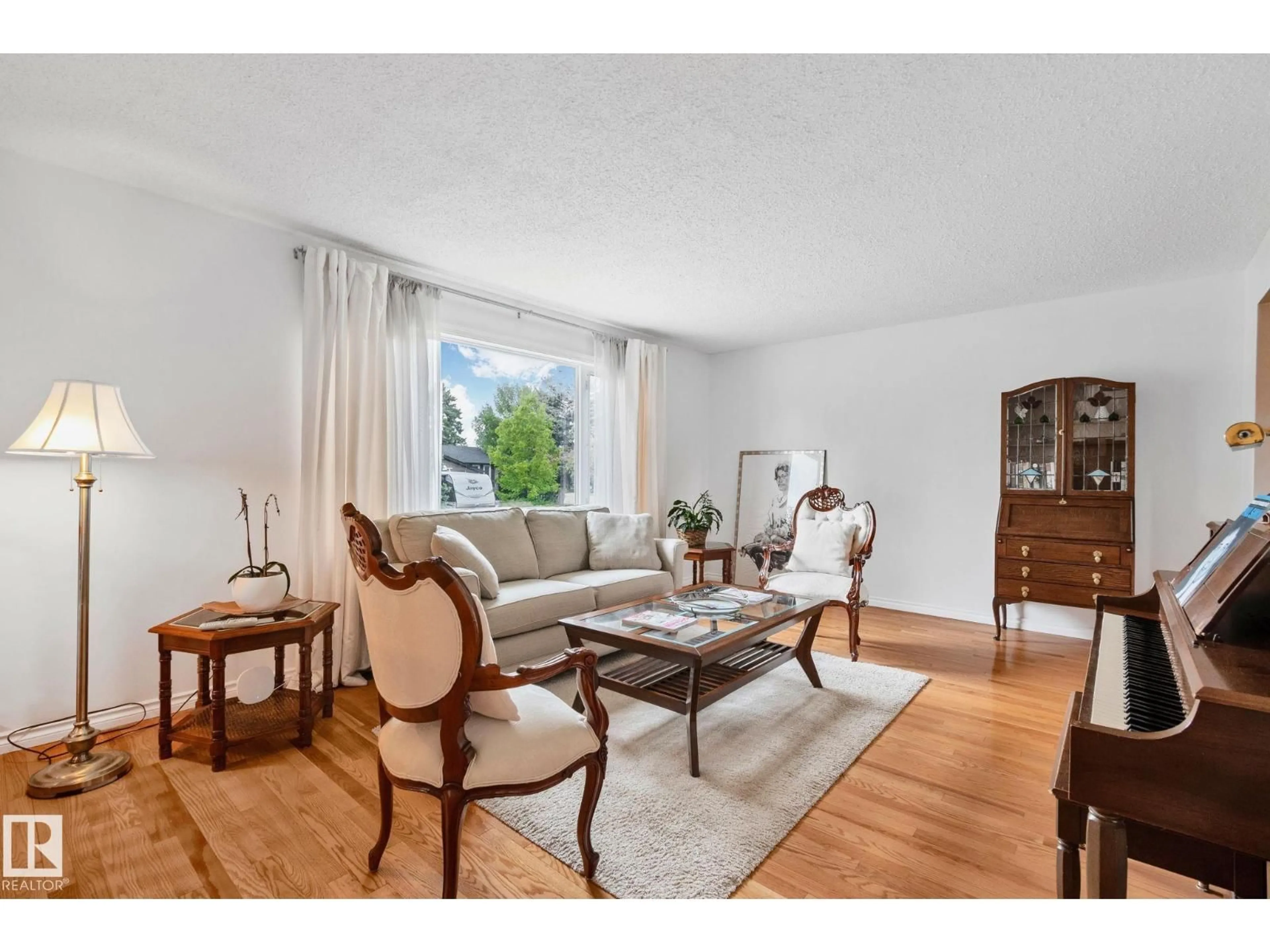 Living room with furniture, wood/laminate floor for 10715 33 AV, Edmonton Alberta T6J2Z2