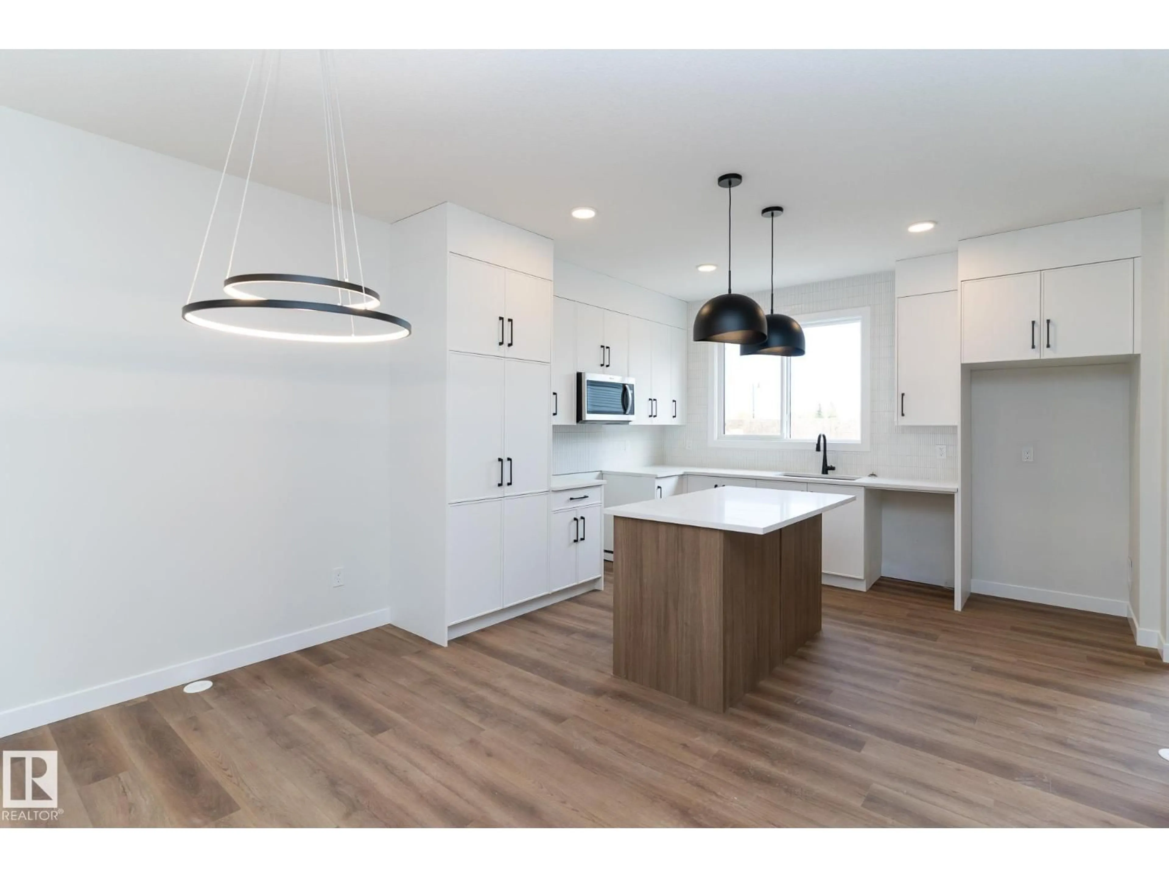 Open concept kitchen, wood/laminate floor for 3319 ROY BROWN WY, Edmonton Alberta T5E6Z9