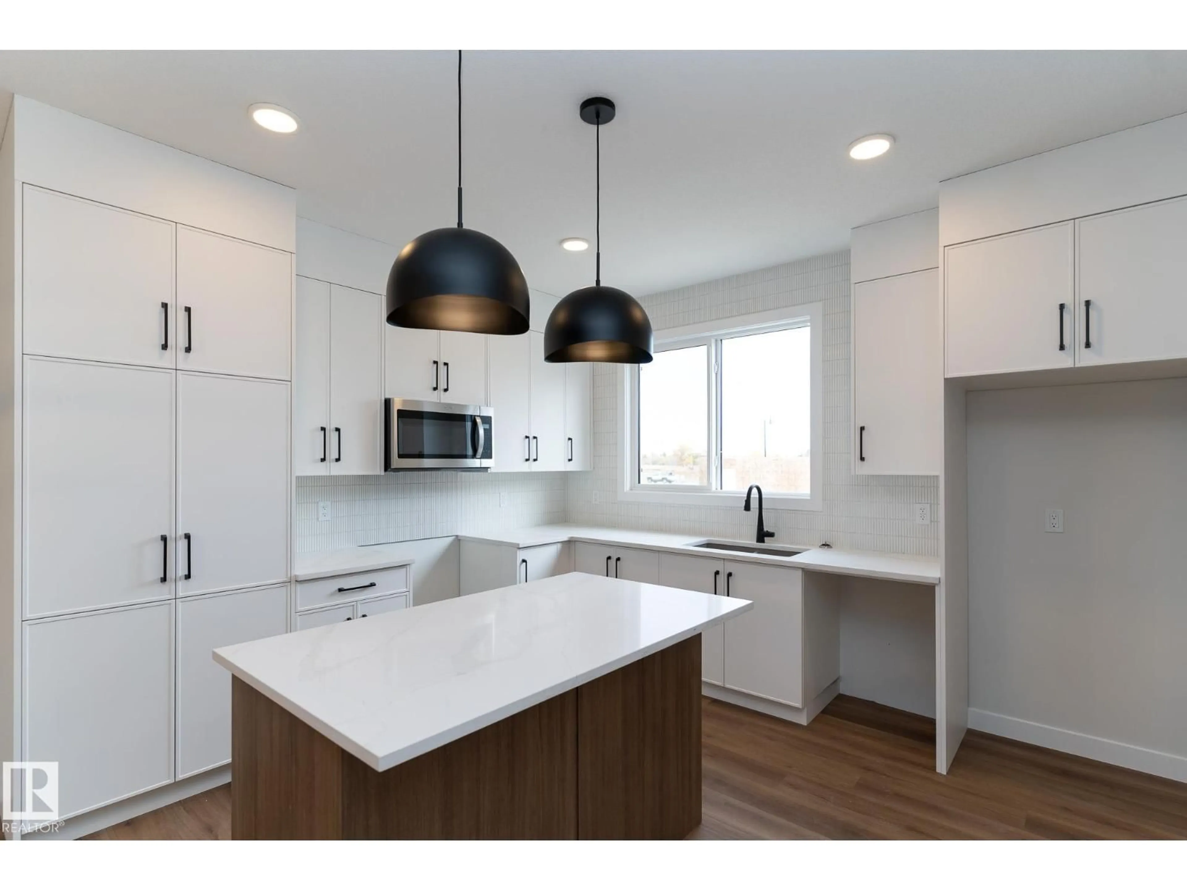 Open concept kitchen, wood/laminate floor for 3319 ROY BROWN WY, Edmonton Alberta T5E6Z9