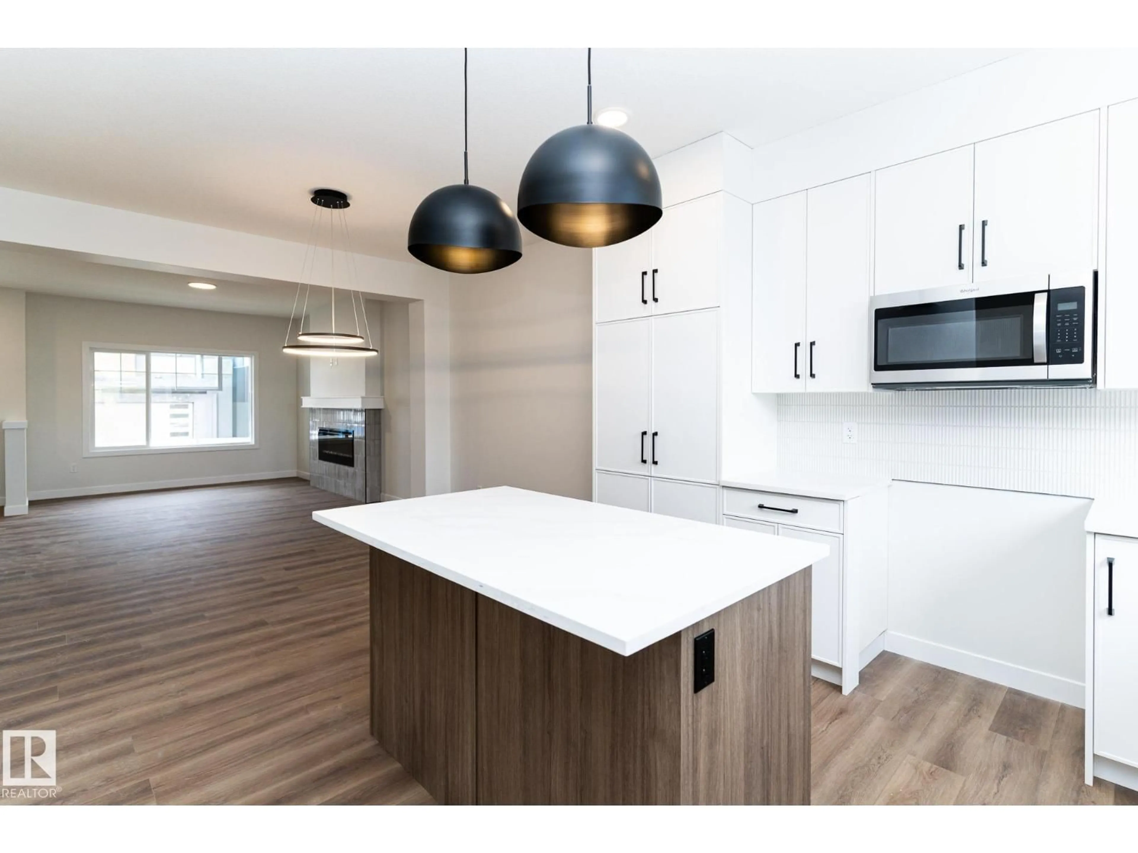 Open concept kitchen, wood/laminate floor for 3319 ROY BROWN WY, Edmonton Alberta T5E6Z9