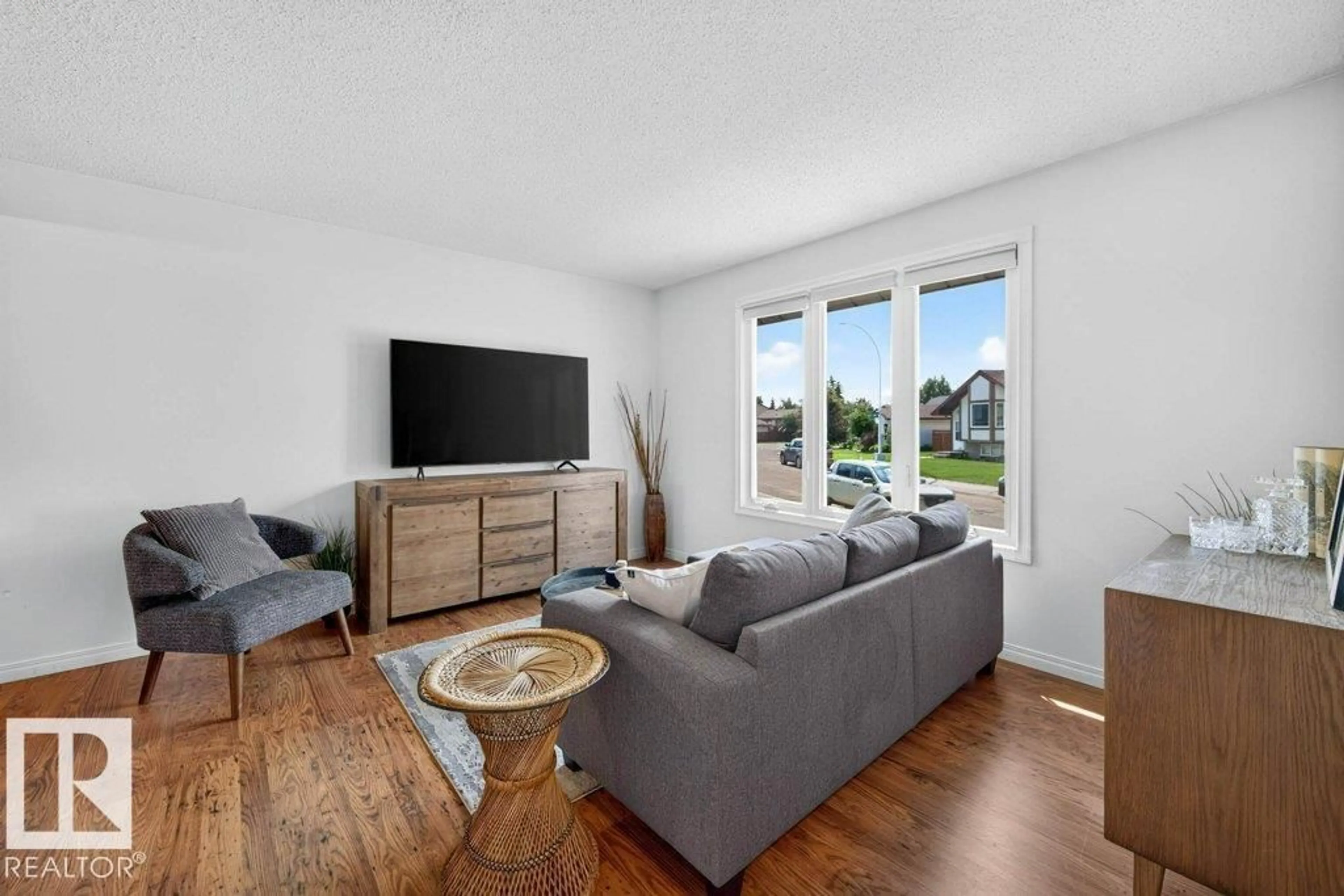 Living room with furniture, wood/laminate floor for 3610 42 AV, Edmonton Alberta T6L5C8
