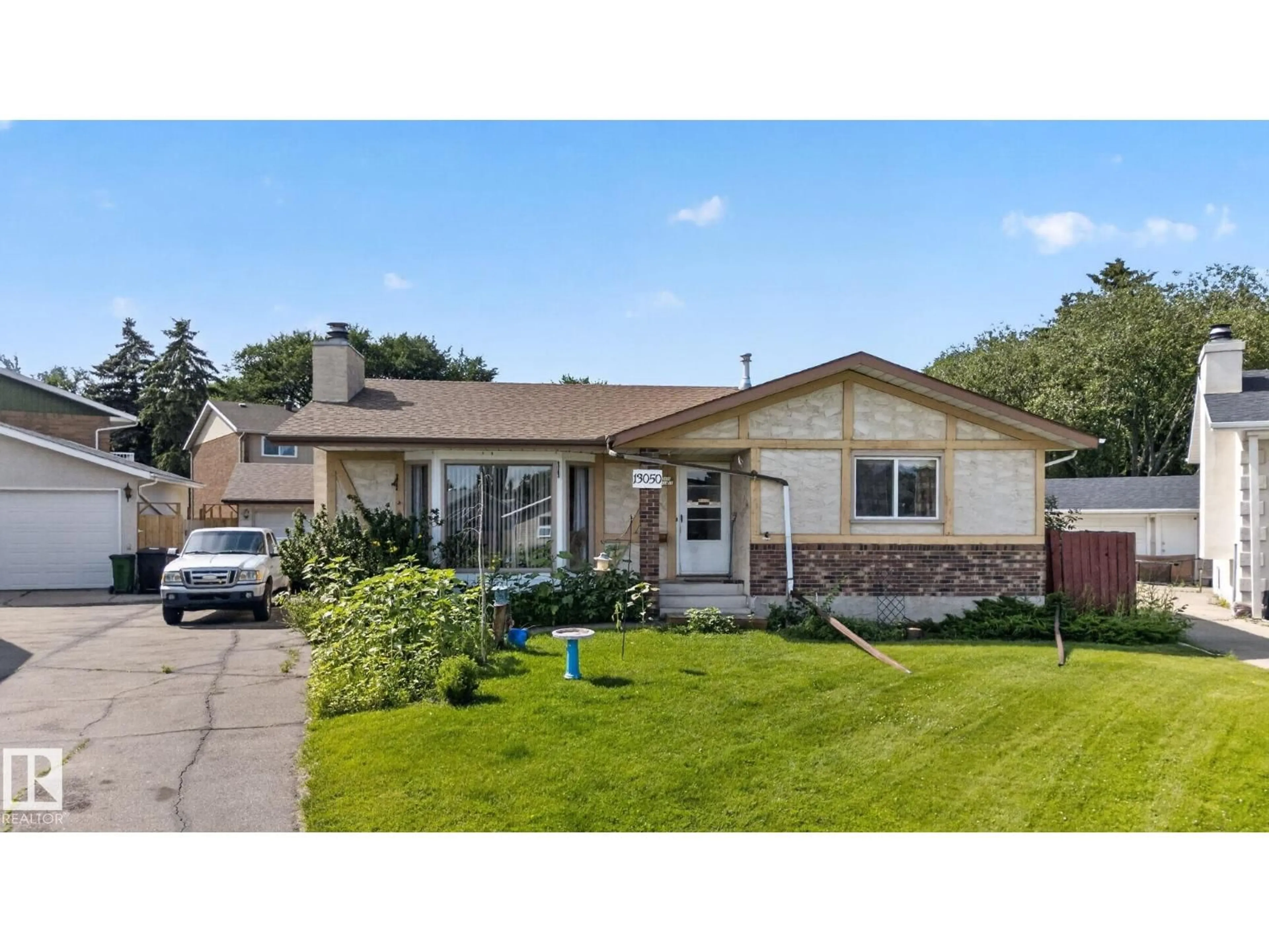 Home with vinyl exterior material, street for NW - 13050 32A ST, Edmonton Alberta T5A3E5
