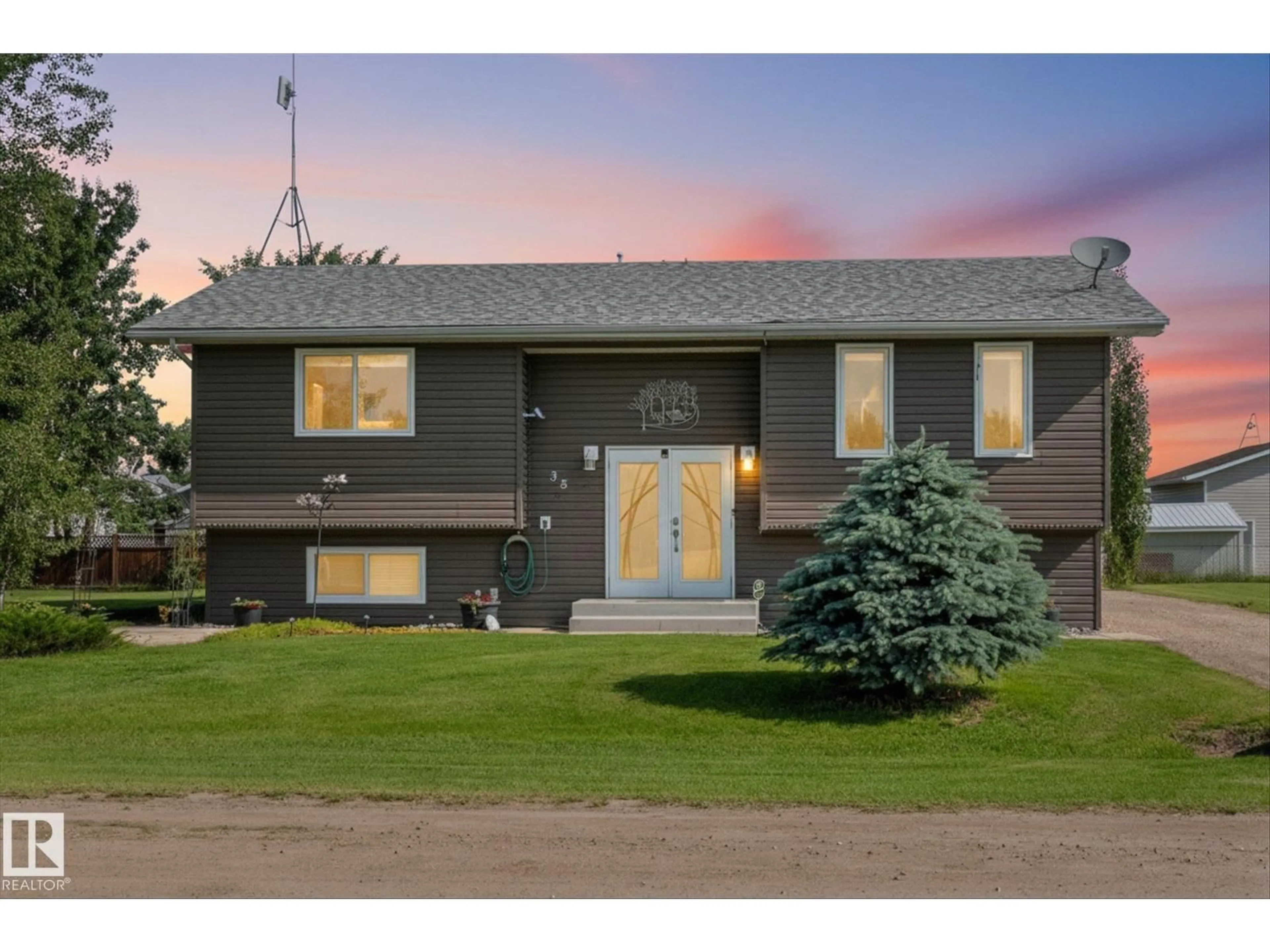 Home with vinyl exterior material, street for 38 WOODBEND CR, Warburg Alberta T0C2T0