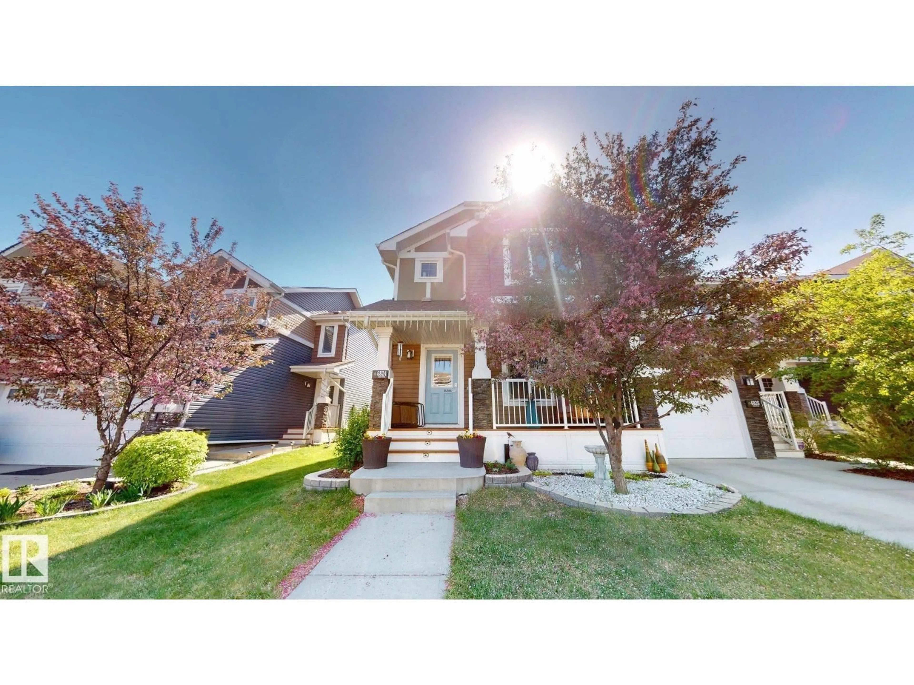 Home with vinyl exterior material, street for 6824 EVANS WD, Edmonton Alberta T6M0T3