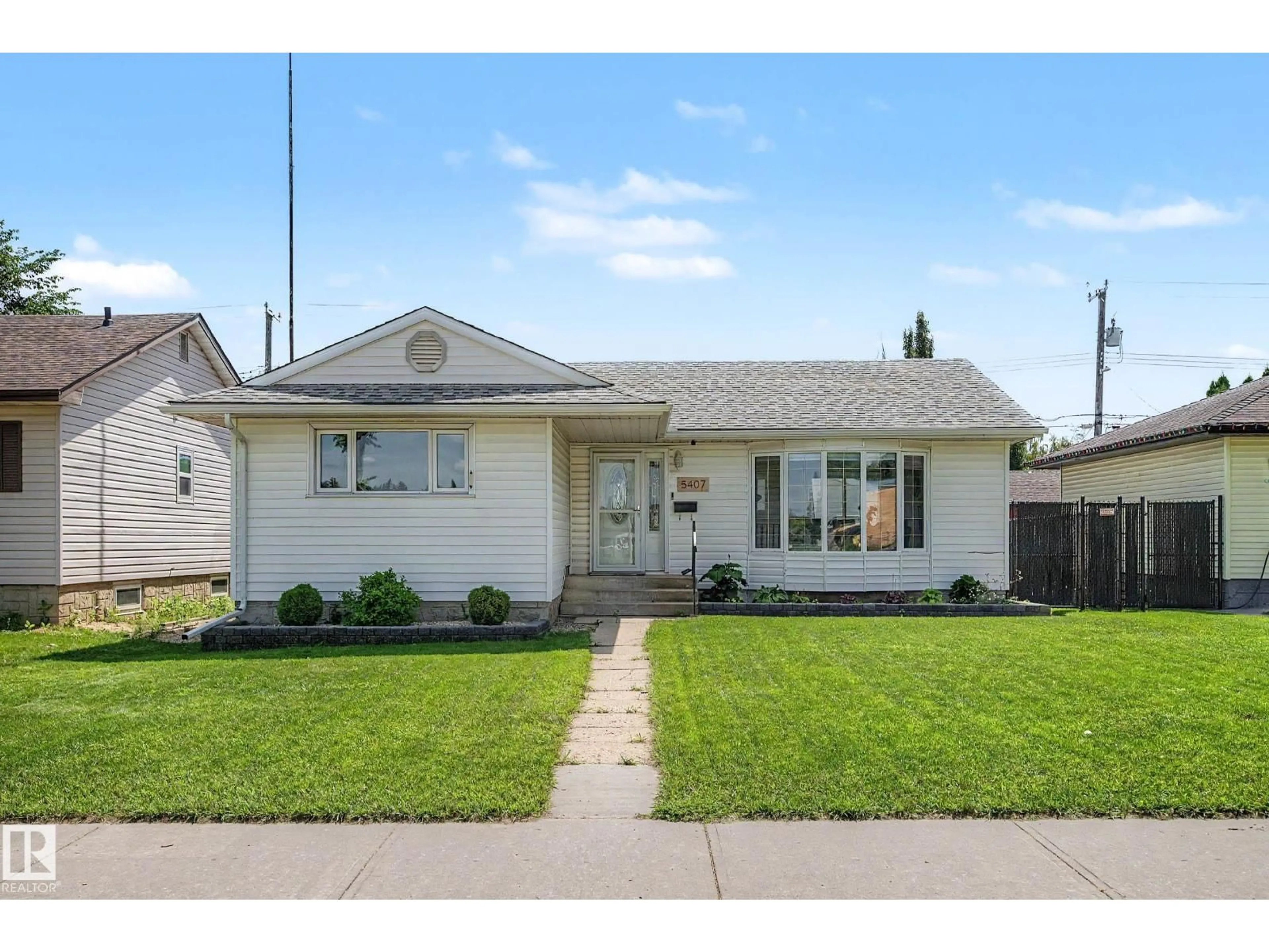 Home with vinyl exterior material, street for 5407 106 AV, Edmonton Alberta T6A1G1