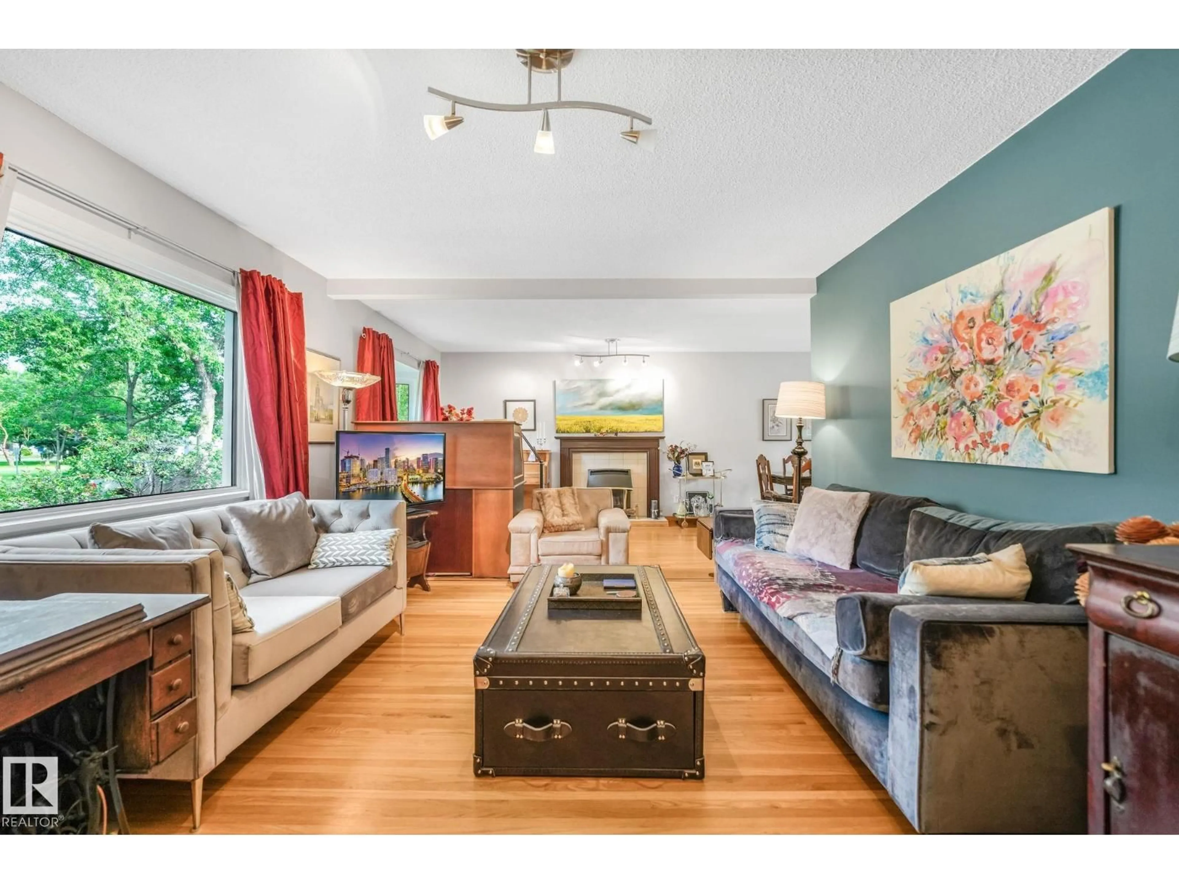 Living room with furniture, wood/laminate floor for NW - 11422 70 ST, Edmonton Alberta T5B1T4