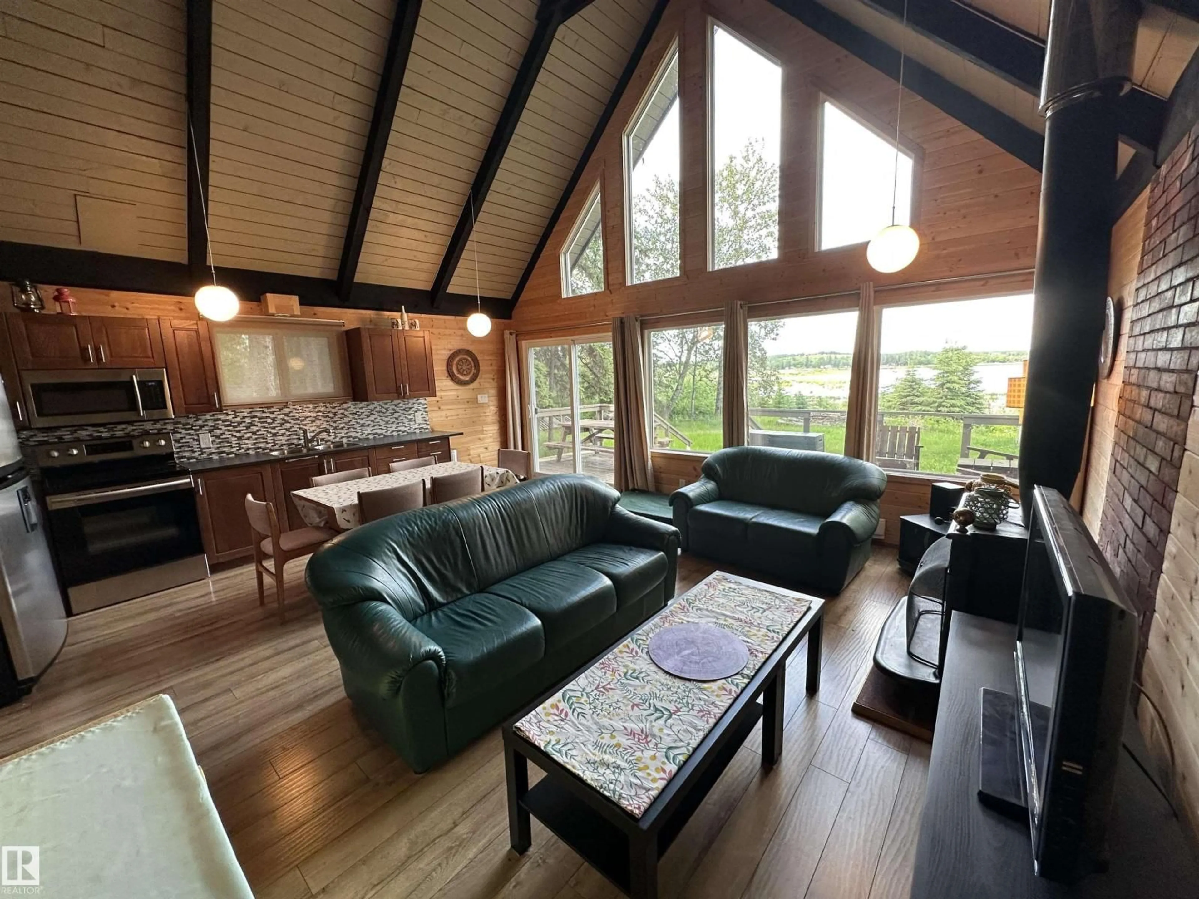 Living room with furniture, wood/laminate floor for 4307 SPRUCE PT, Rural Lac Ste. Anne County Alberta T0E1V0