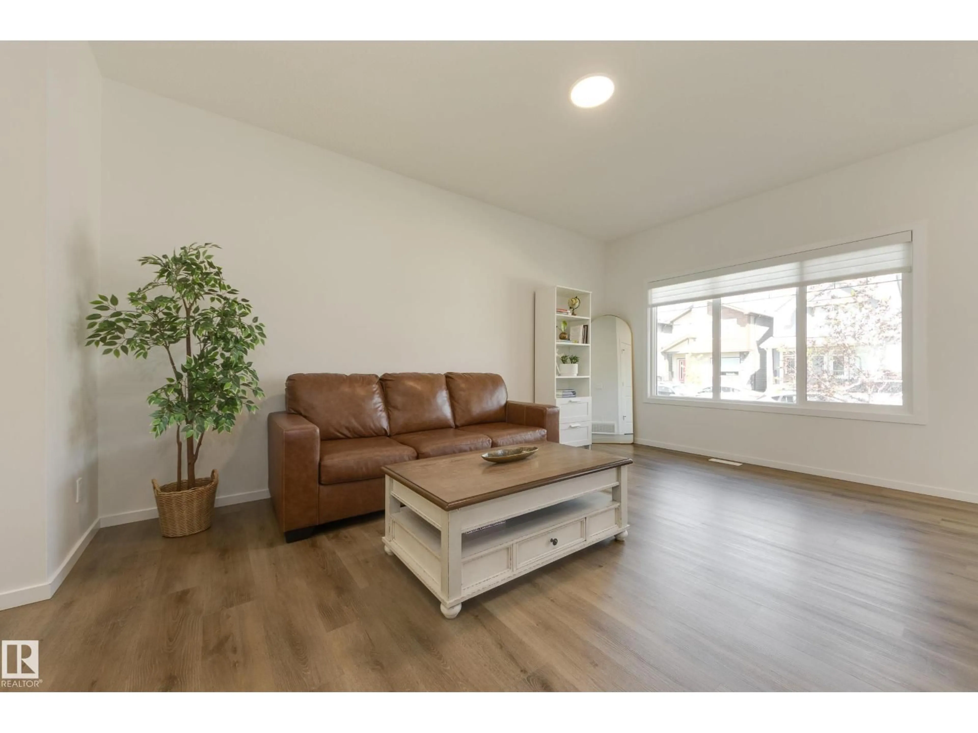 Living room with furniture, wood/laminate floor for 2804 193 ST, Edmonton Alberta T6M3B2