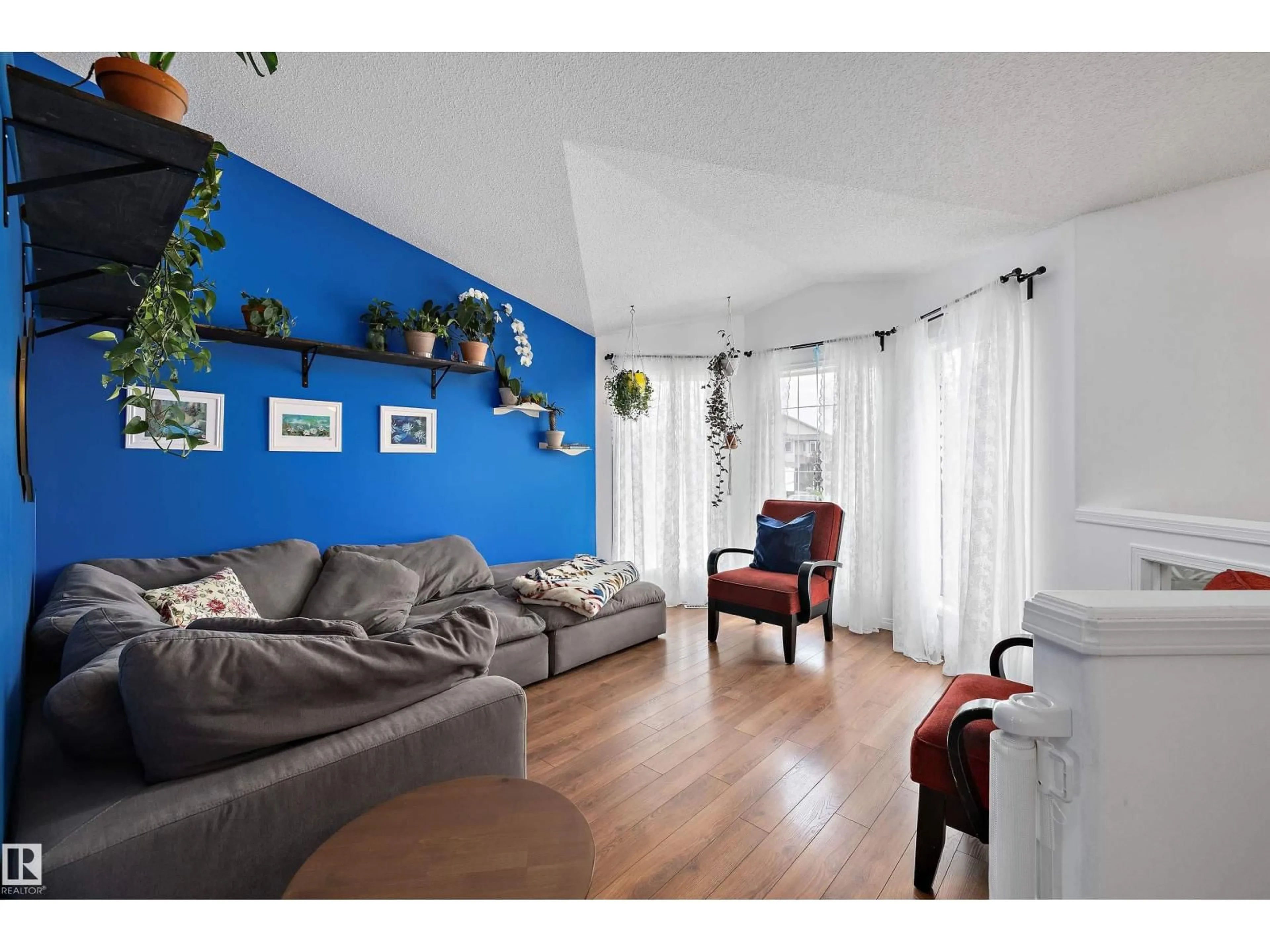 Living room with furniture, wood/laminate floor for 3624 130 AV, Edmonton Alberta T5A4G1