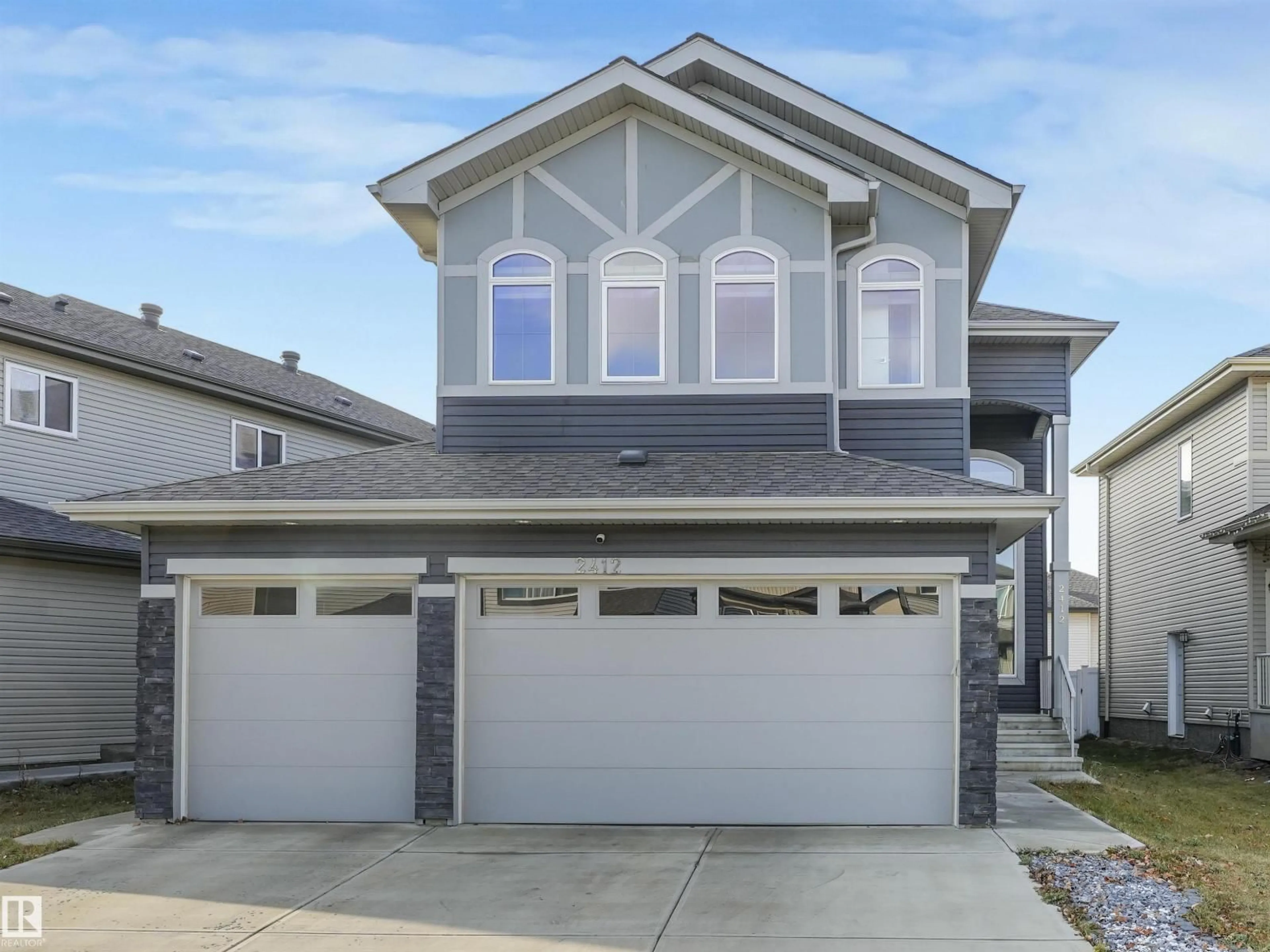 Home with vinyl exterior material, street for 2412 14 AV, Edmonton Alberta T6T2J8