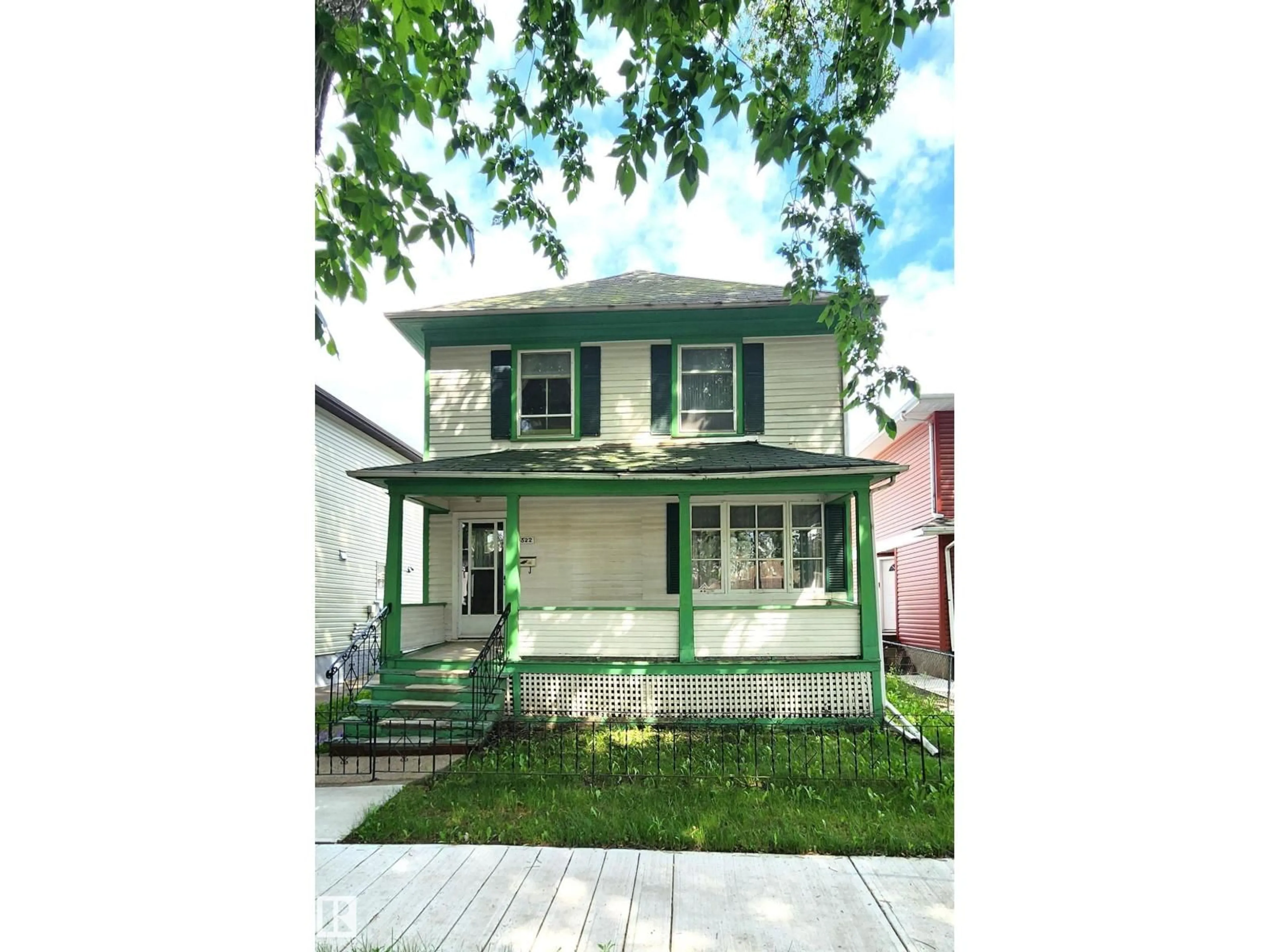 Home with vinyl exterior material, street for 9522 110 AV NW, Edmonton Alberta T5H1H4