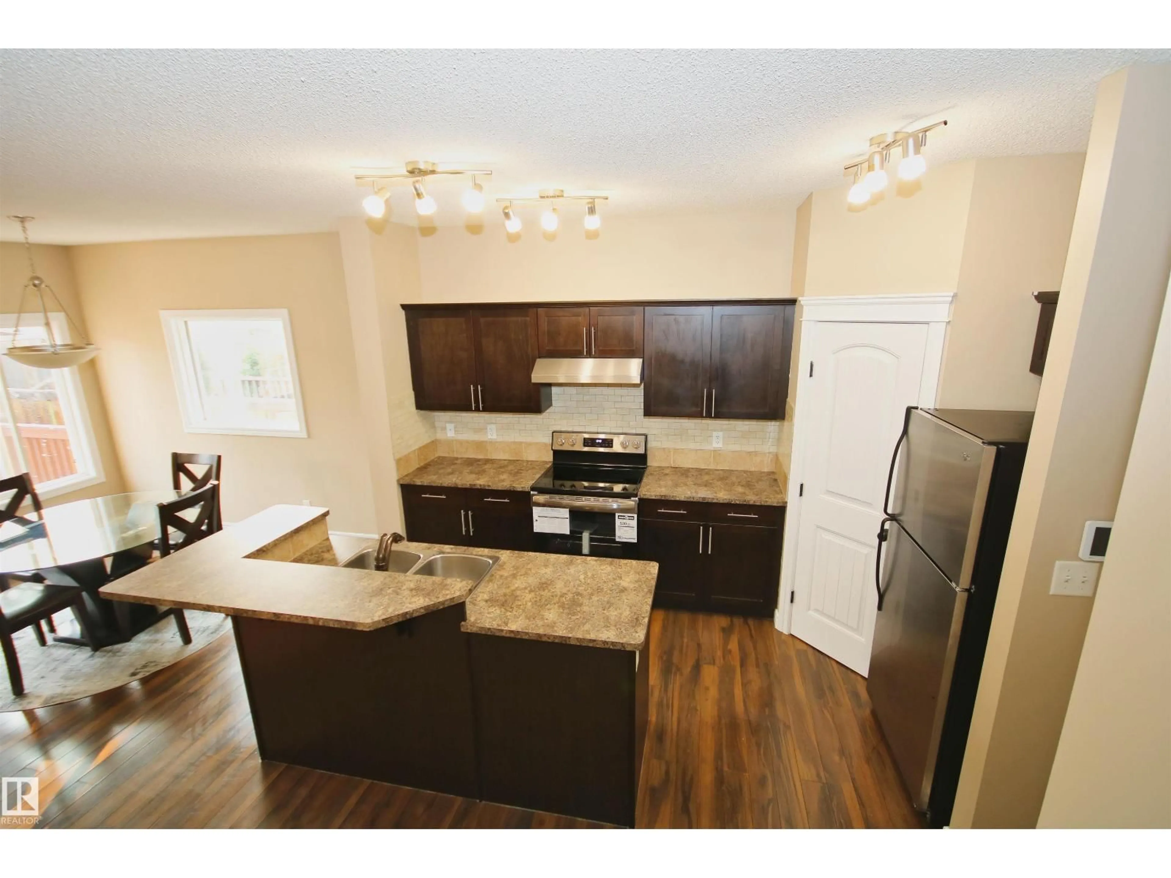 Open concept kitchen, wood/laminate floor for 11513 17 AV, Edmonton Alberta T6W1Y4