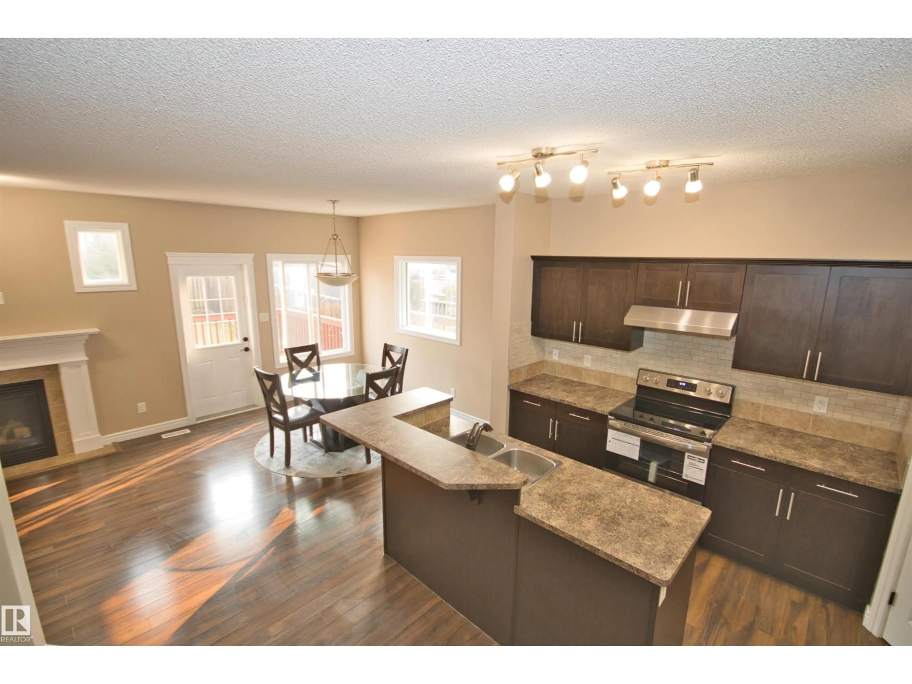 Open concept kitchen, wood/laminate floor for 11513 17 AV, Edmonton Alberta T6W1Y4