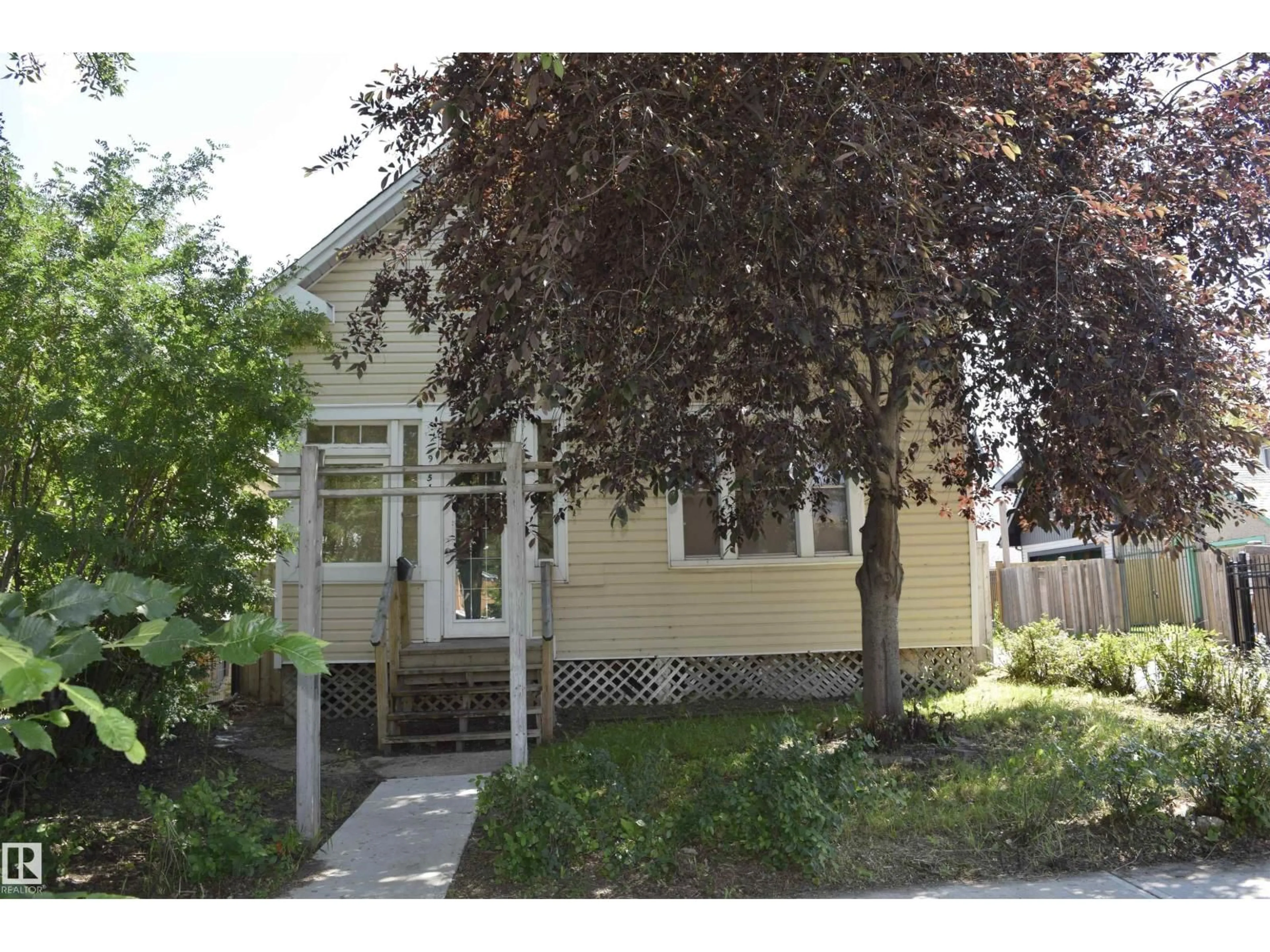 Home with vinyl exterior material, street for 9551 106A AV, Edmonton Alberta T5H0S9