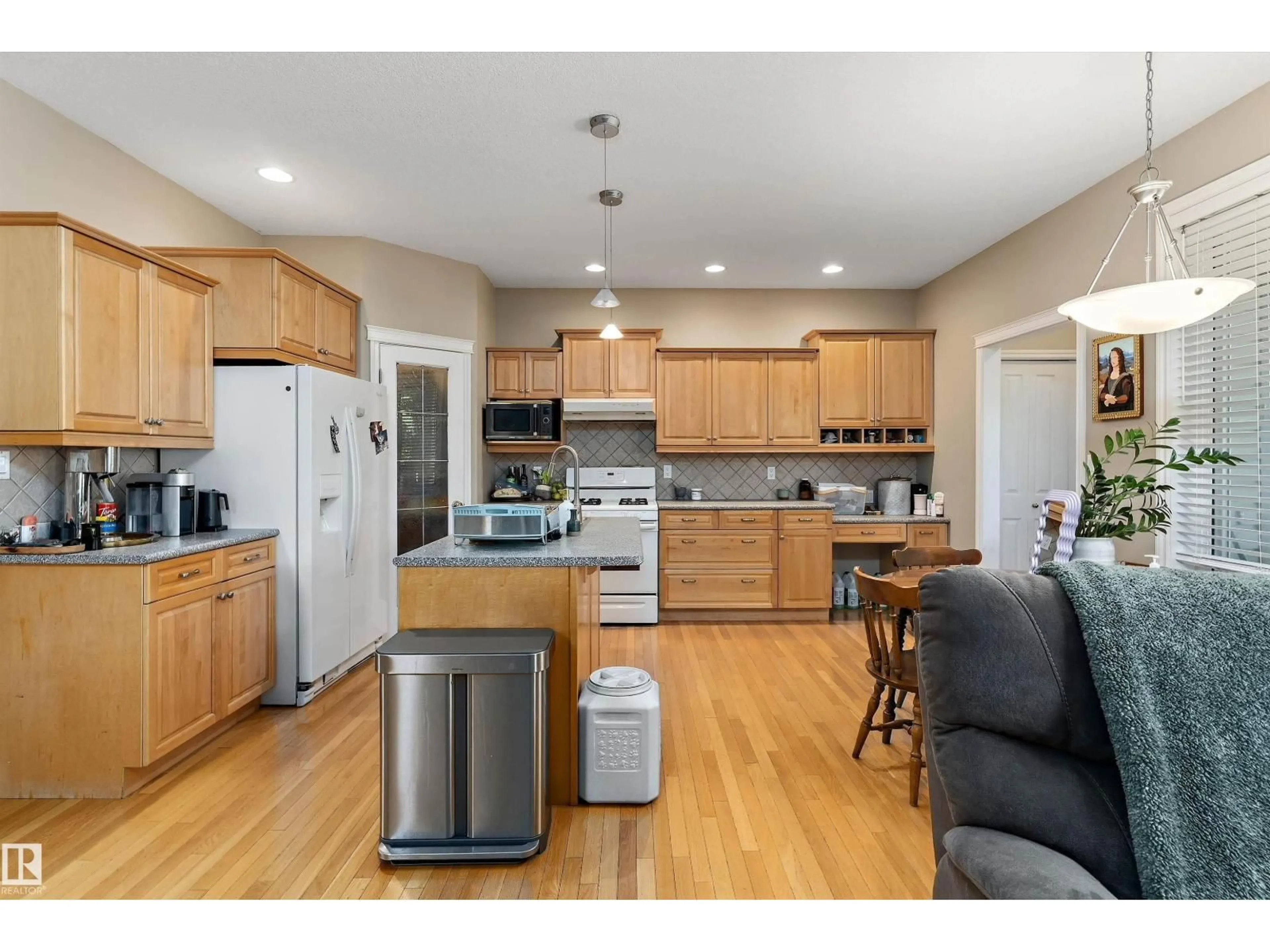 Open concept kitchen, wood/laminate floor for 10506 82 ST, Edmonton Alberta T6A3M8