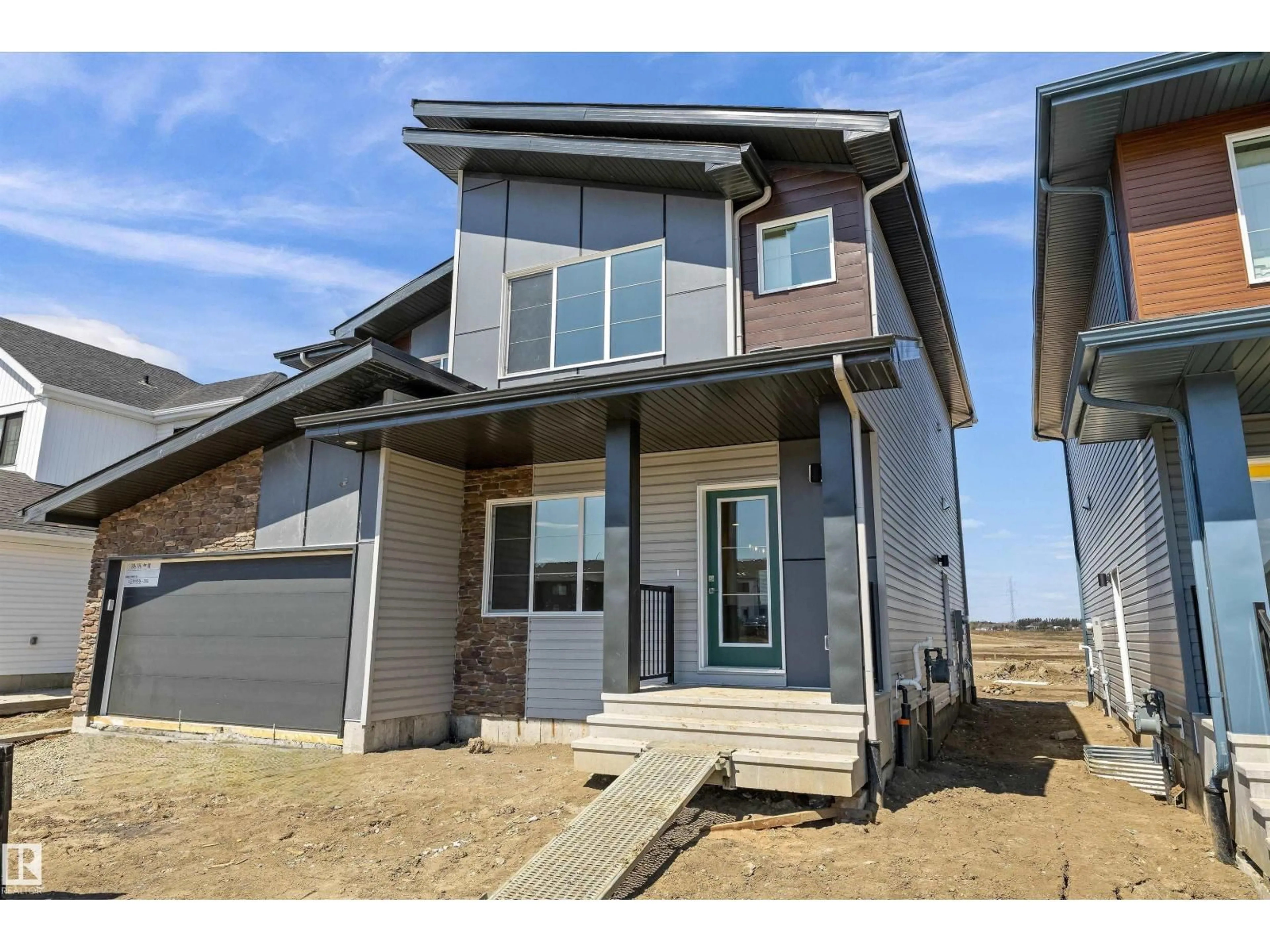 Home with vinyl exterior material, street for 618 176 AV, Edmonton Alberta T5Y4J9