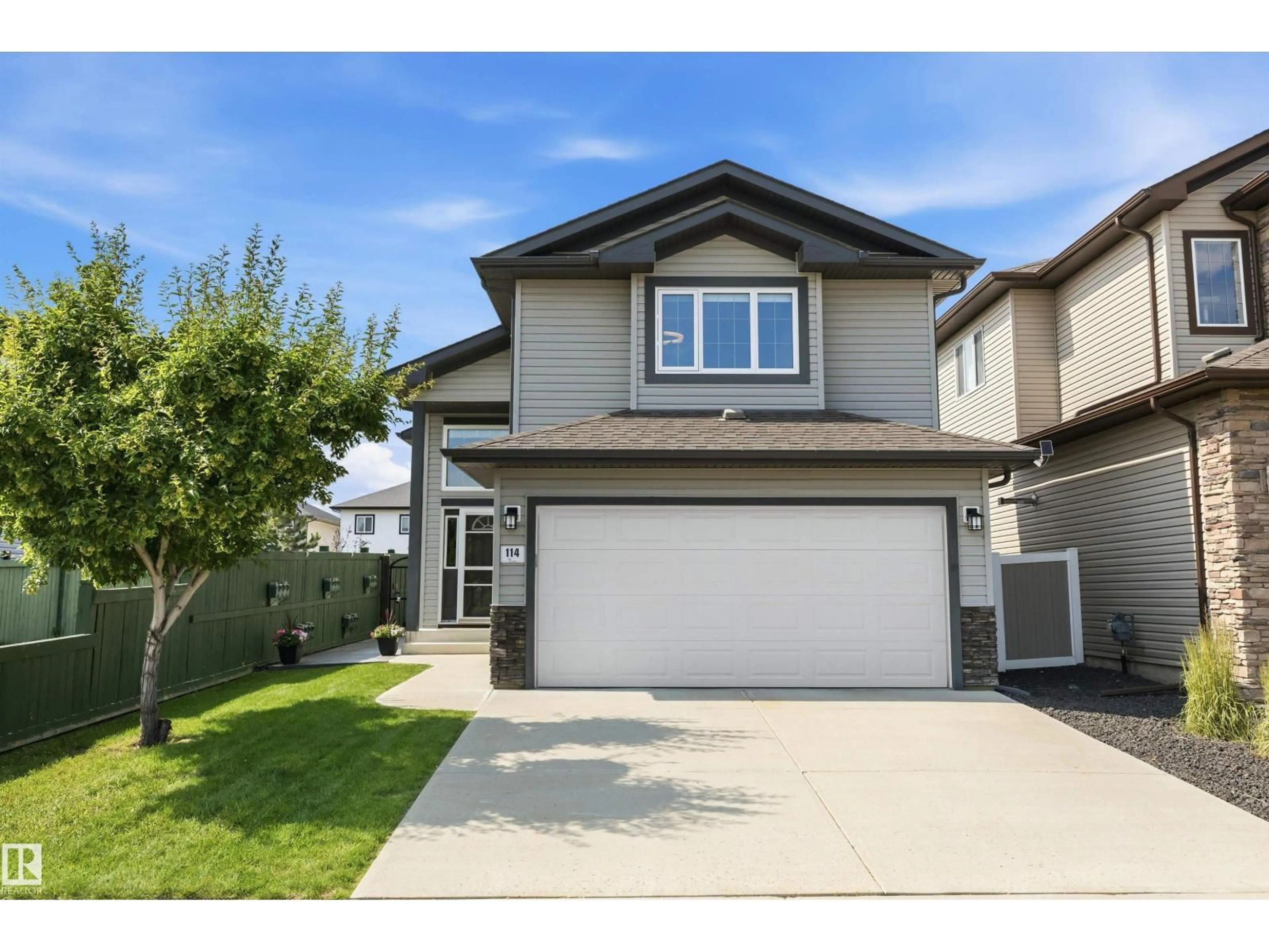Home with vinyl exterior material, street for 114 WOODHILL LN, Fort Saskatchewan Alberta T8L0L8