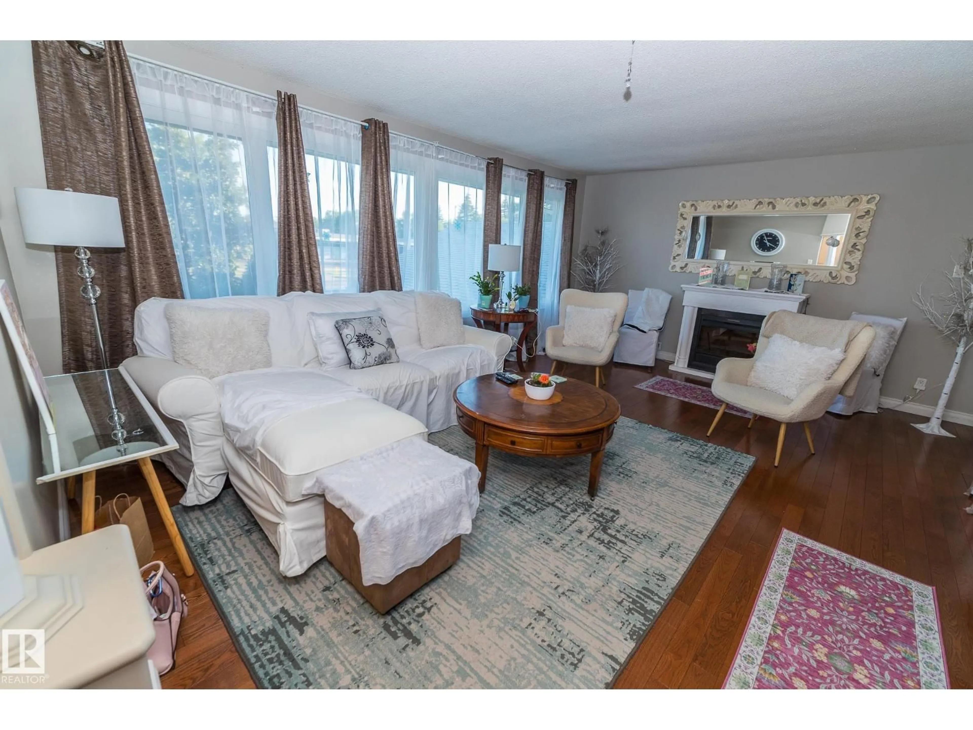 Living room with furniture, wood/laminate floor for NW - 14904 107 AV, Edmonton Alberta T5P4Z2