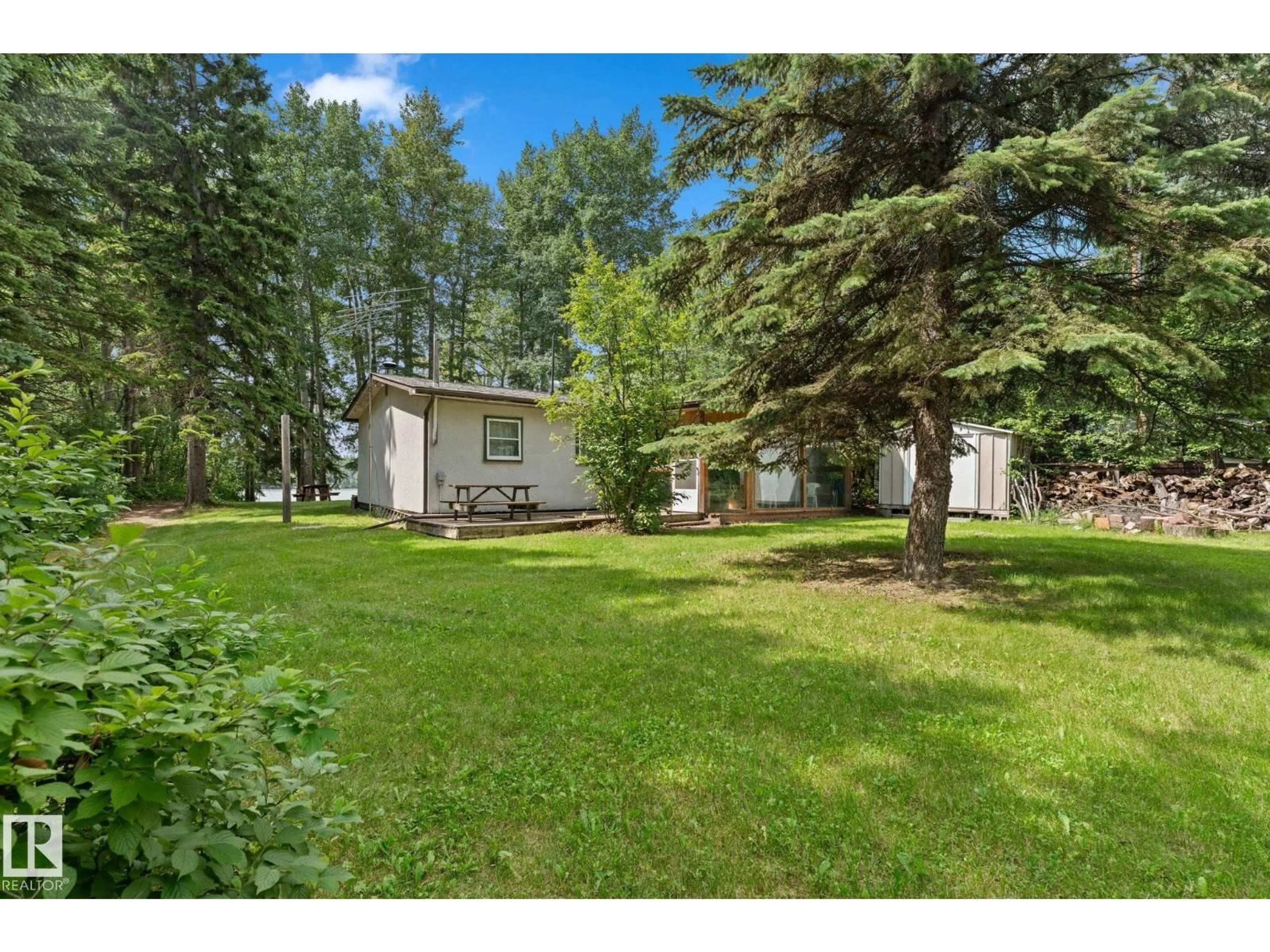 A pic from outside/outdoor area/front of a property/back of a property/a pic from drone, forest/trees view for 490 - 48057 RGE RD 272, Rural Leduc County Alberta T0C2C0