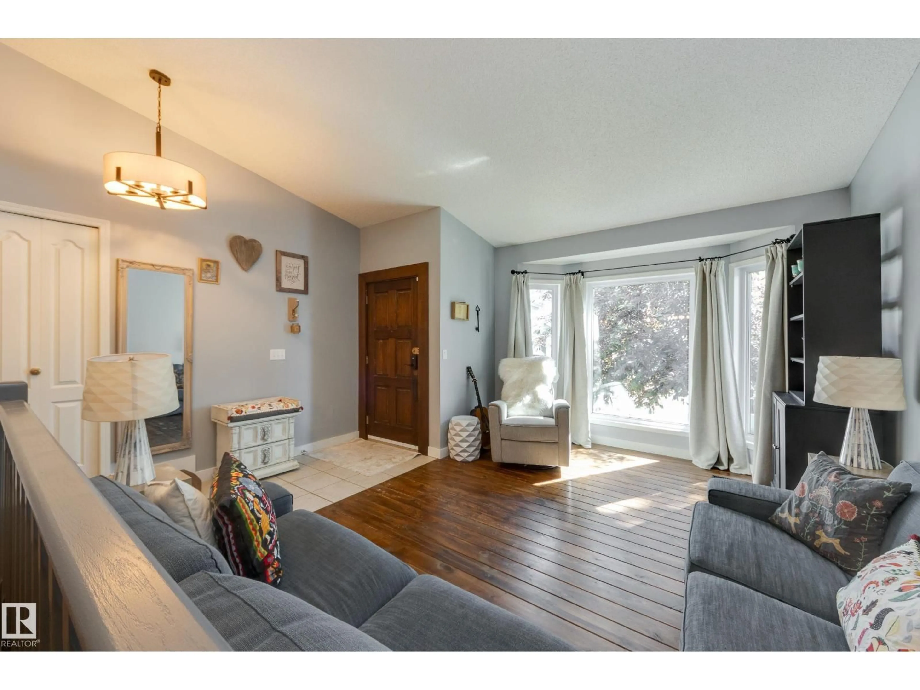 Living room with furniture, wood/laminate floor for 4810 42 ST, Beaumont Alberta T4X1H2
