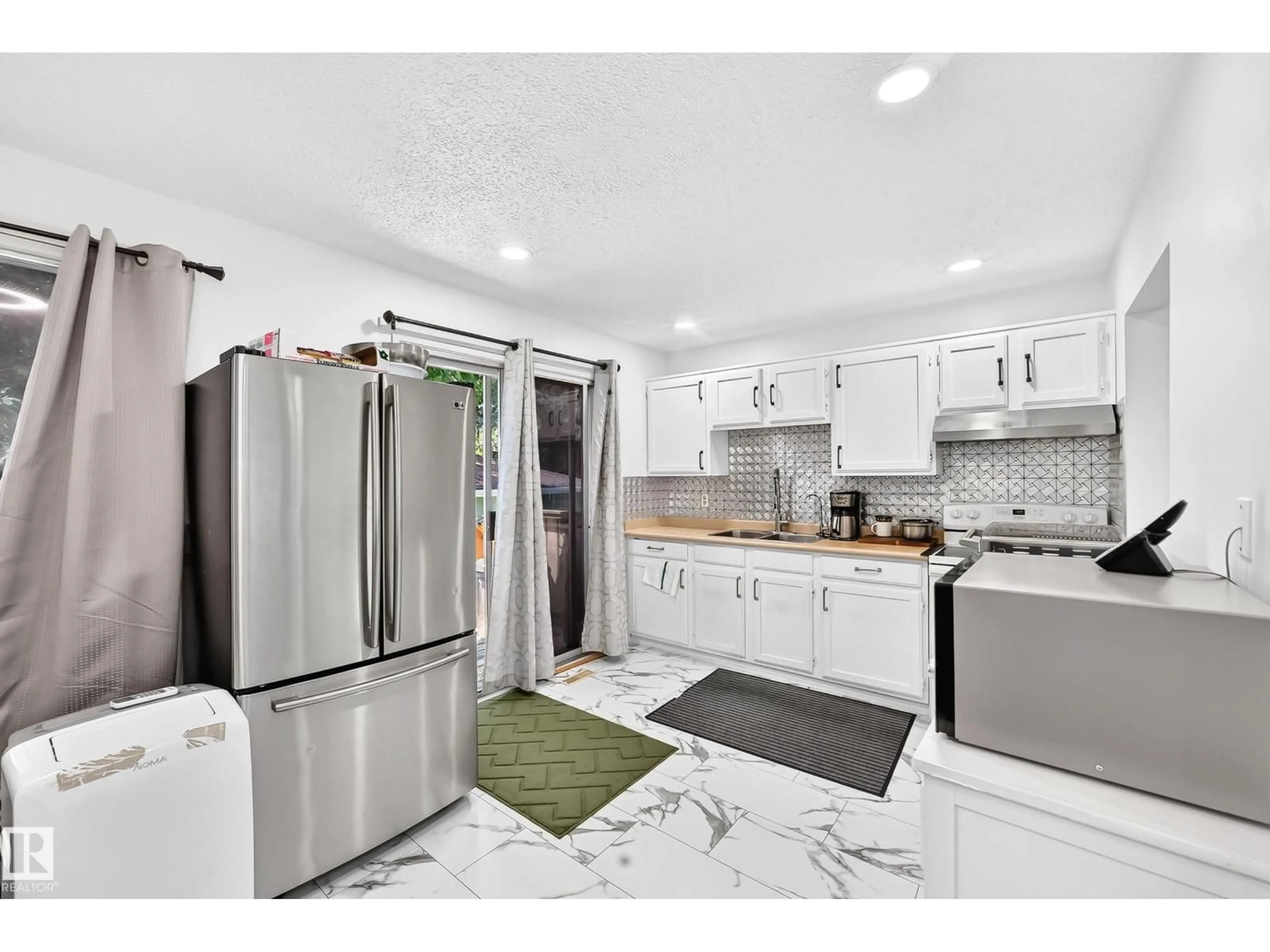 Open concept kitchen, ceramic/tile floor for 14240 23 ST, Edmonton Alberta T5Y1E8