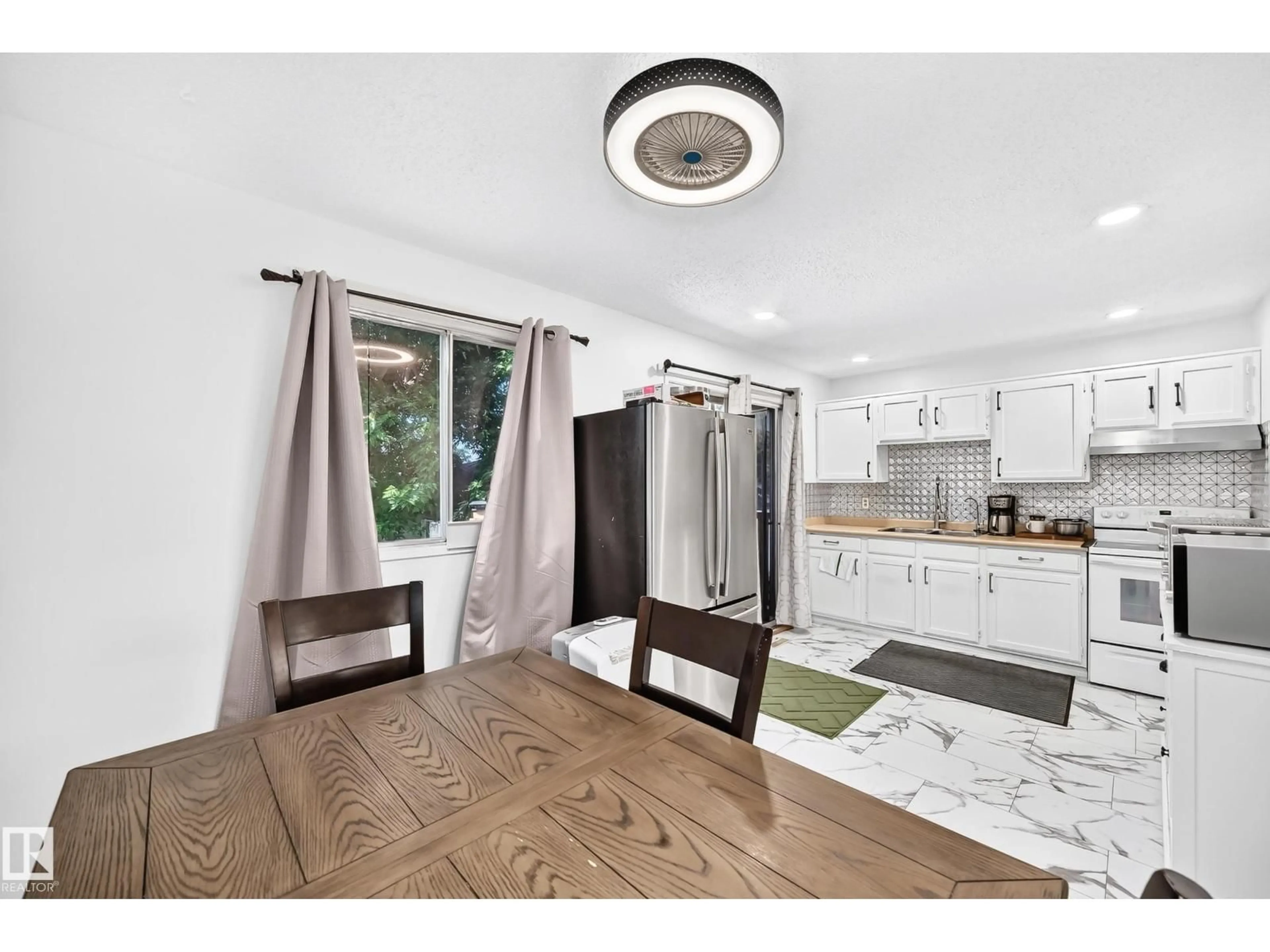 Open concept kitchen, wood/laminate floor for 14240 23 ST, Edmonton Alberta T5Y1E8