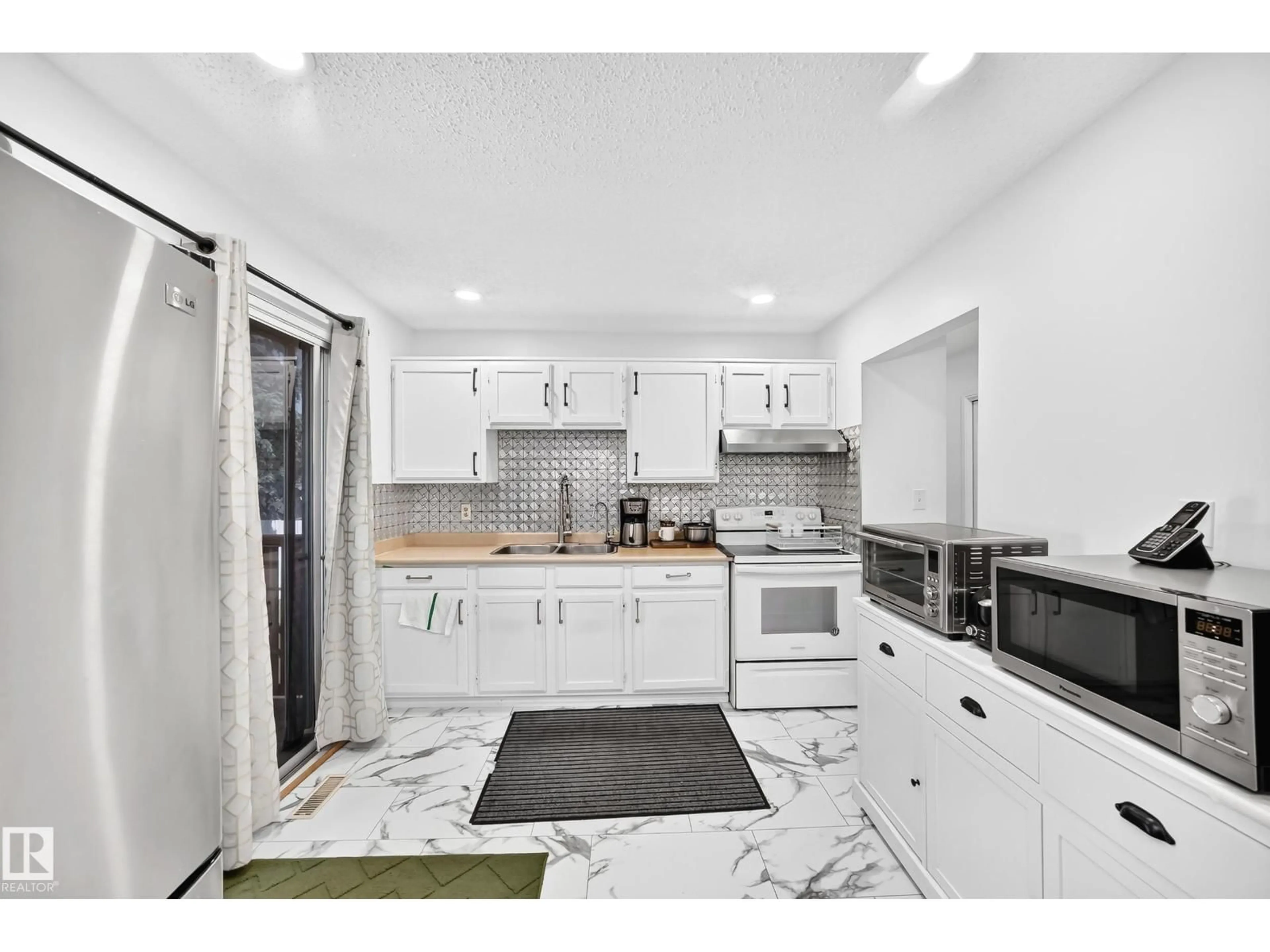 Open concept kitchen, ceramic/tile floor for 14240 23 ST, Edmonton Alberta T5Y1E8
