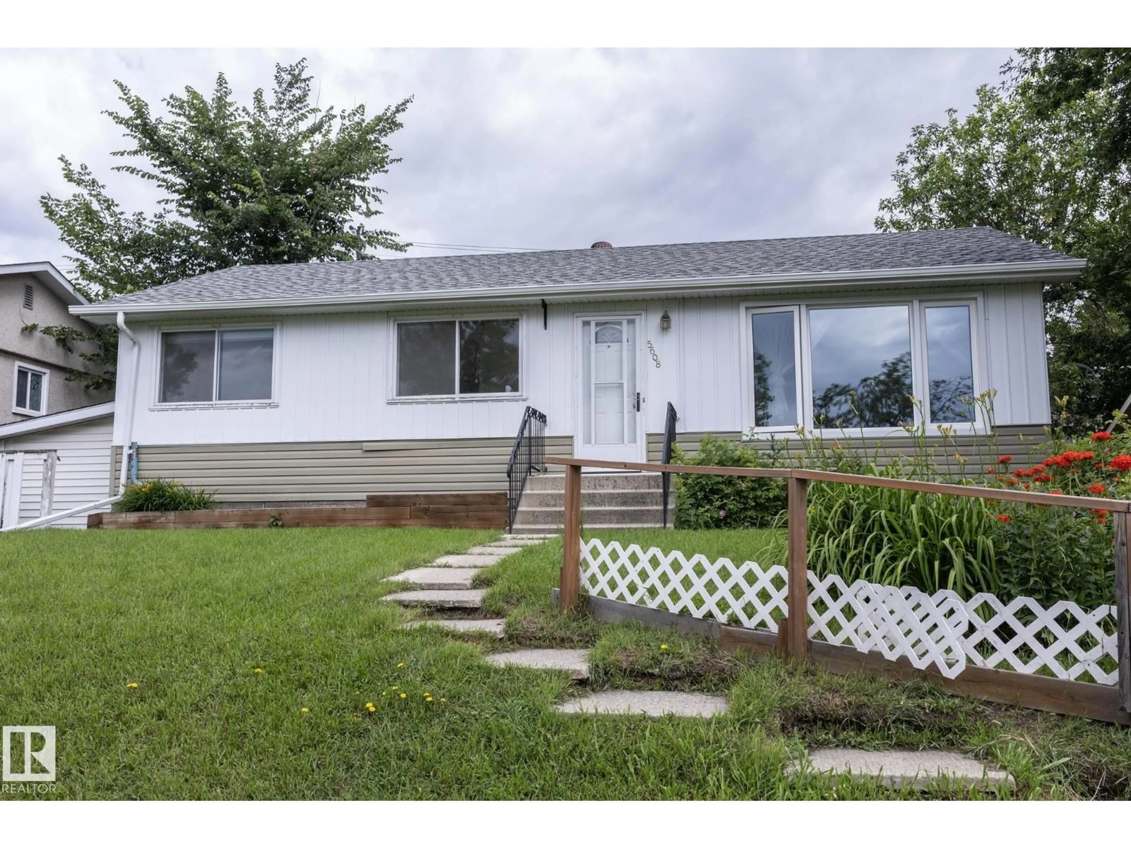 Home with vinyl exterior material, street for NW - 5608 122 AV, Edmonton Alberta T5W1S5