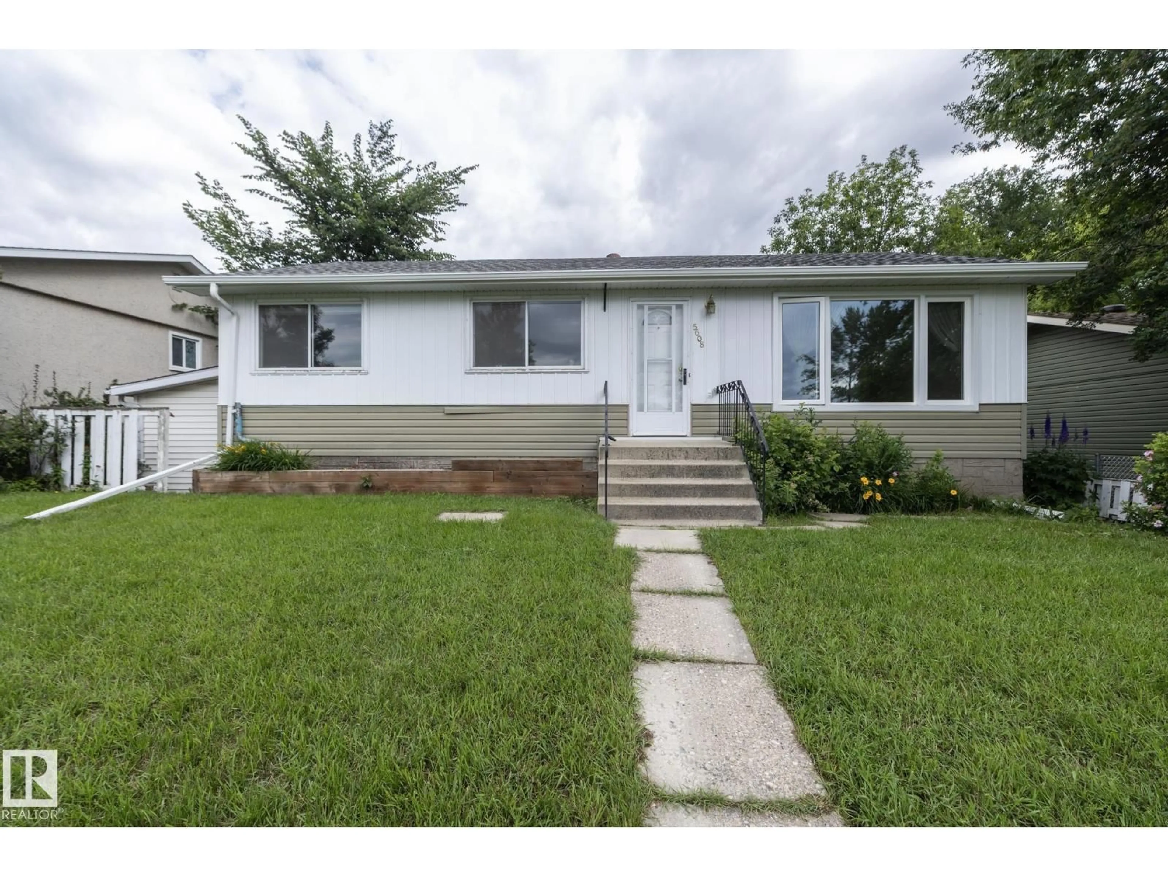 Home with vinyl exterior material, street for NW - 5608 122 AV, Edmonton Alberta T5W1S5