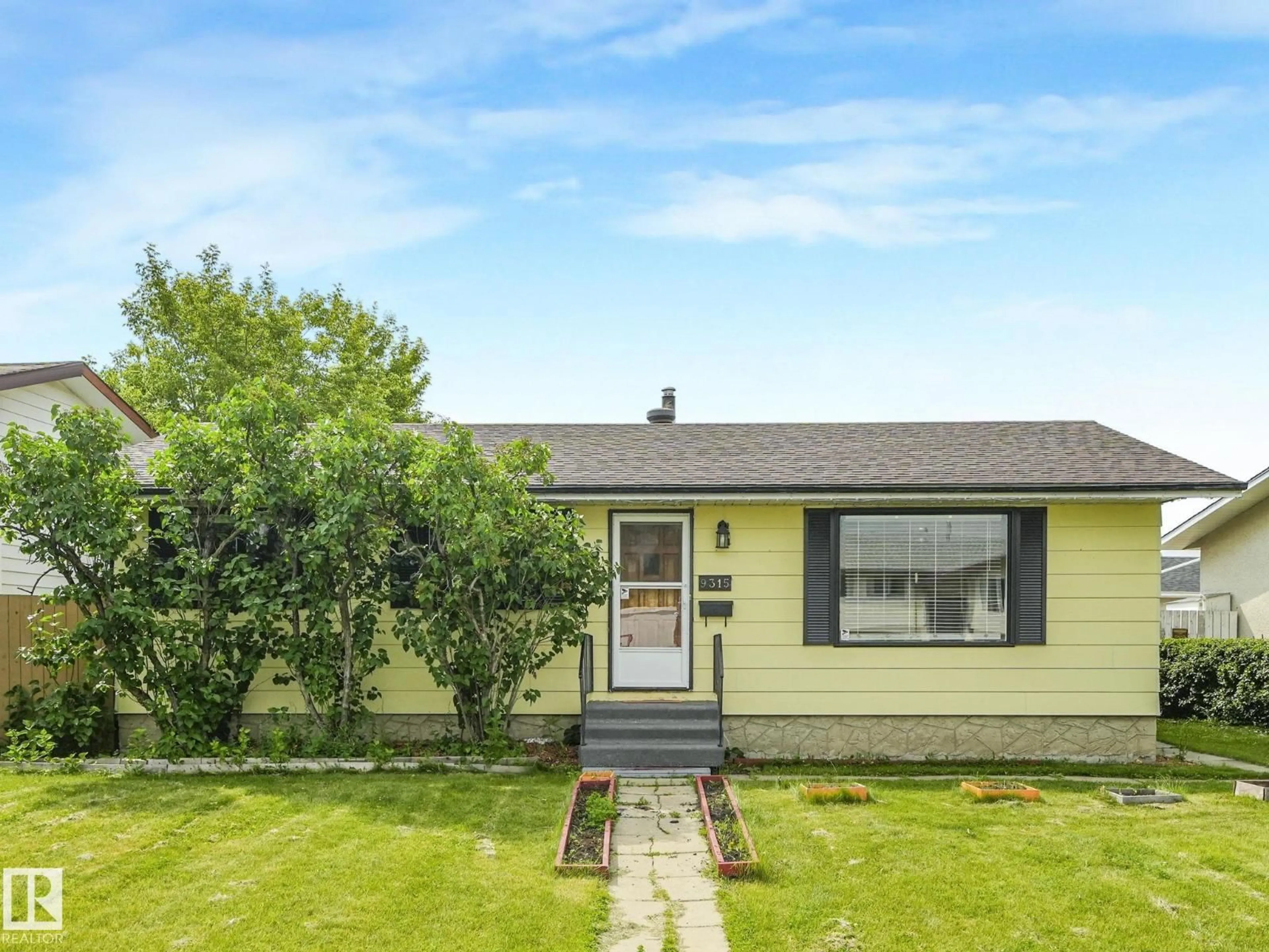 Home with vinyl exterior material, street for 9315 151 AV, Edmonton Alberta T5E2R1
