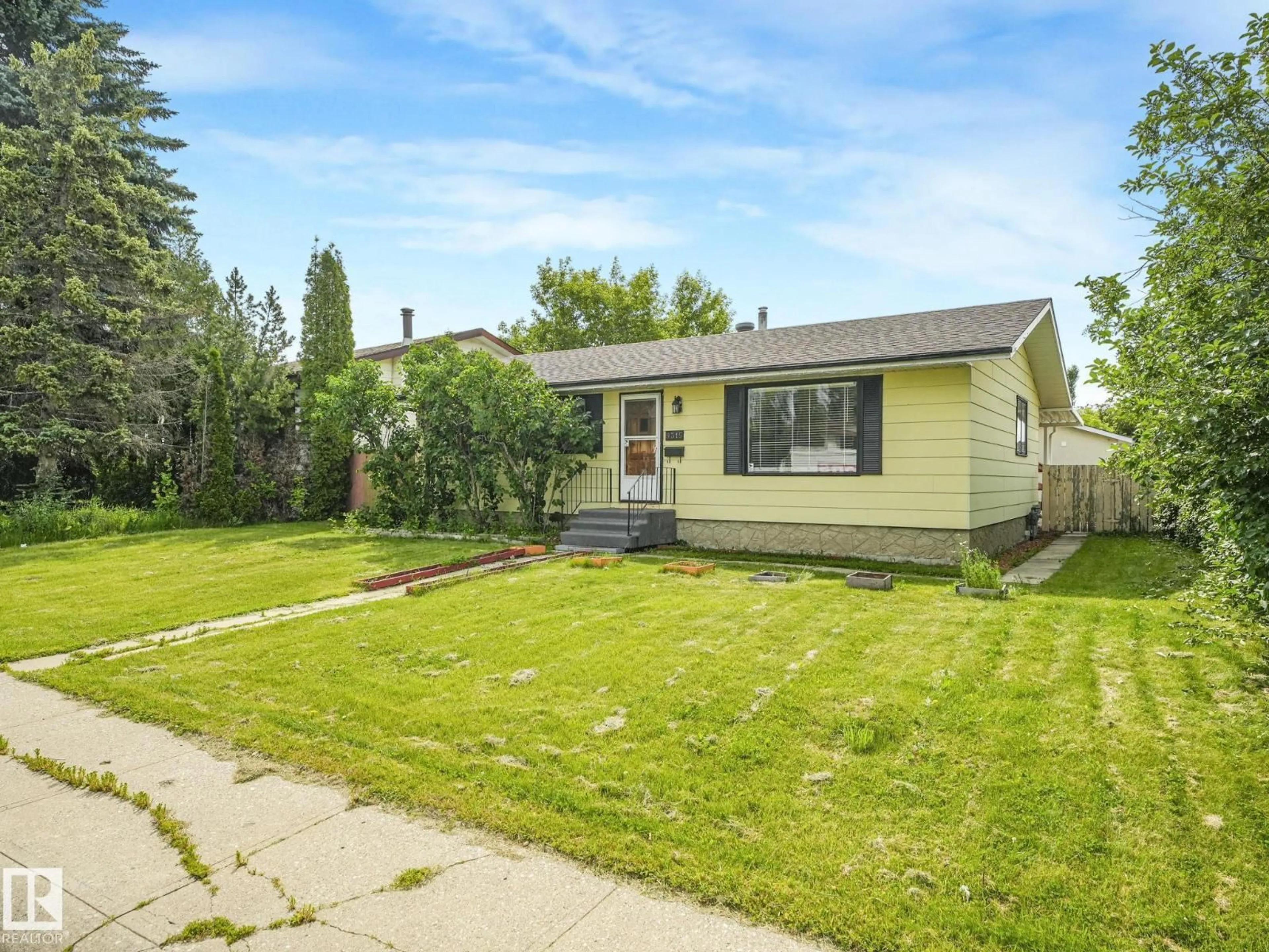 Home with vinyl exterior material, street for 9315 151 AV, Edmonton Alberta T5E2R1