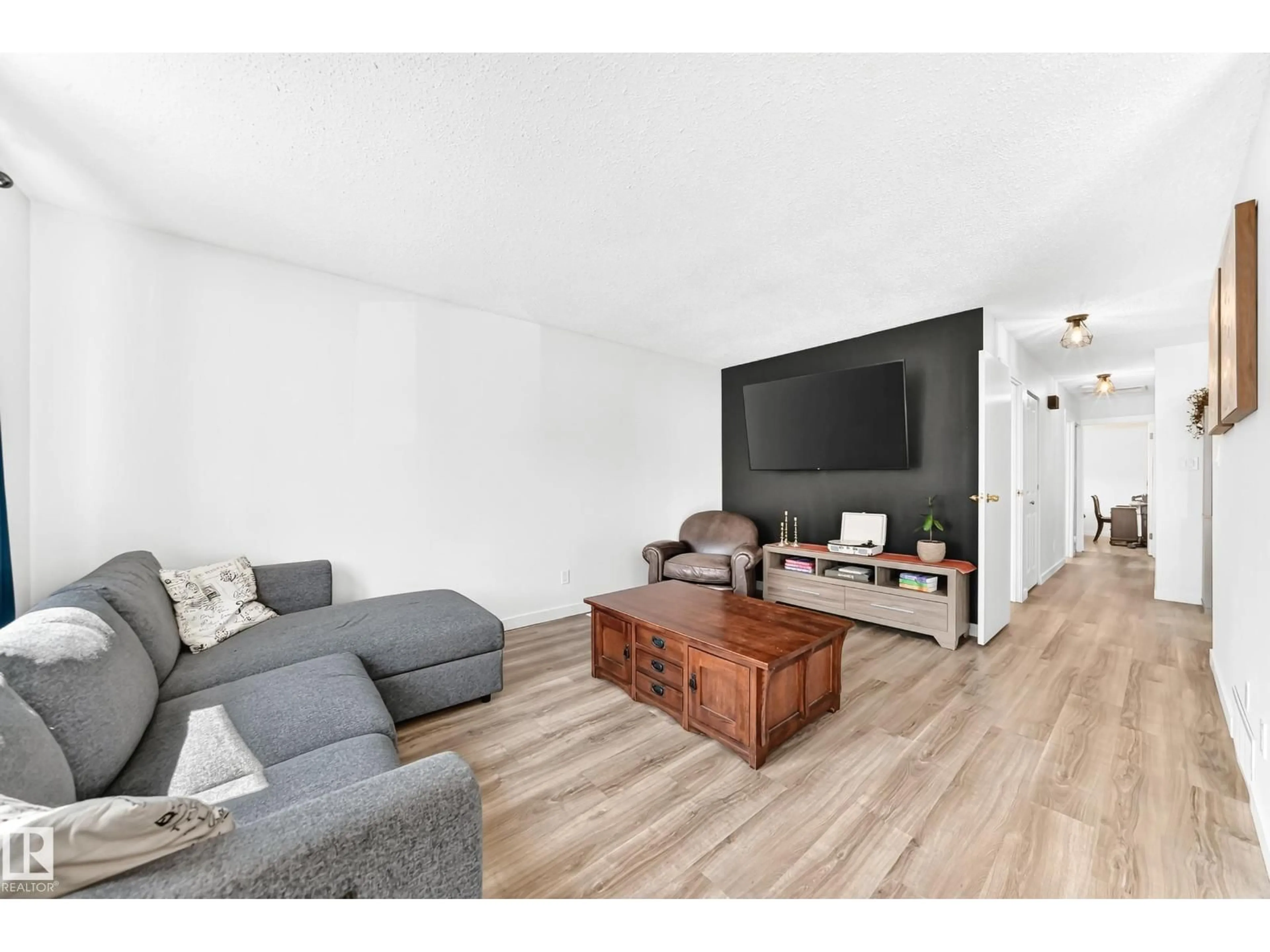 Living room with furniture, wood/laminate floor for 4228 114 AV, Edmonton Alberta T5W0T2