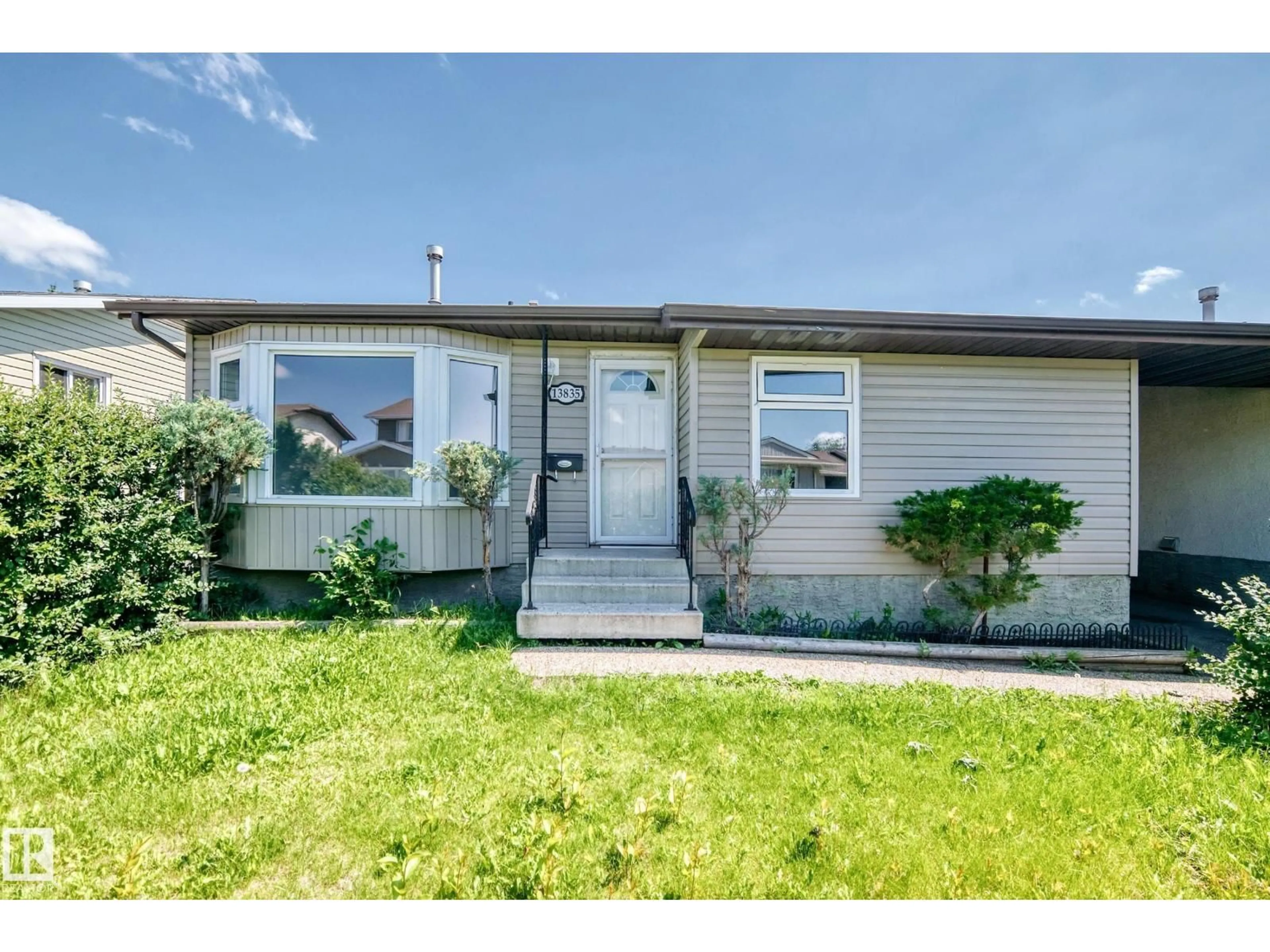 Home with vinyl exterior material, street for 13835 114 ST, Edmonton Alberta T5X4A1