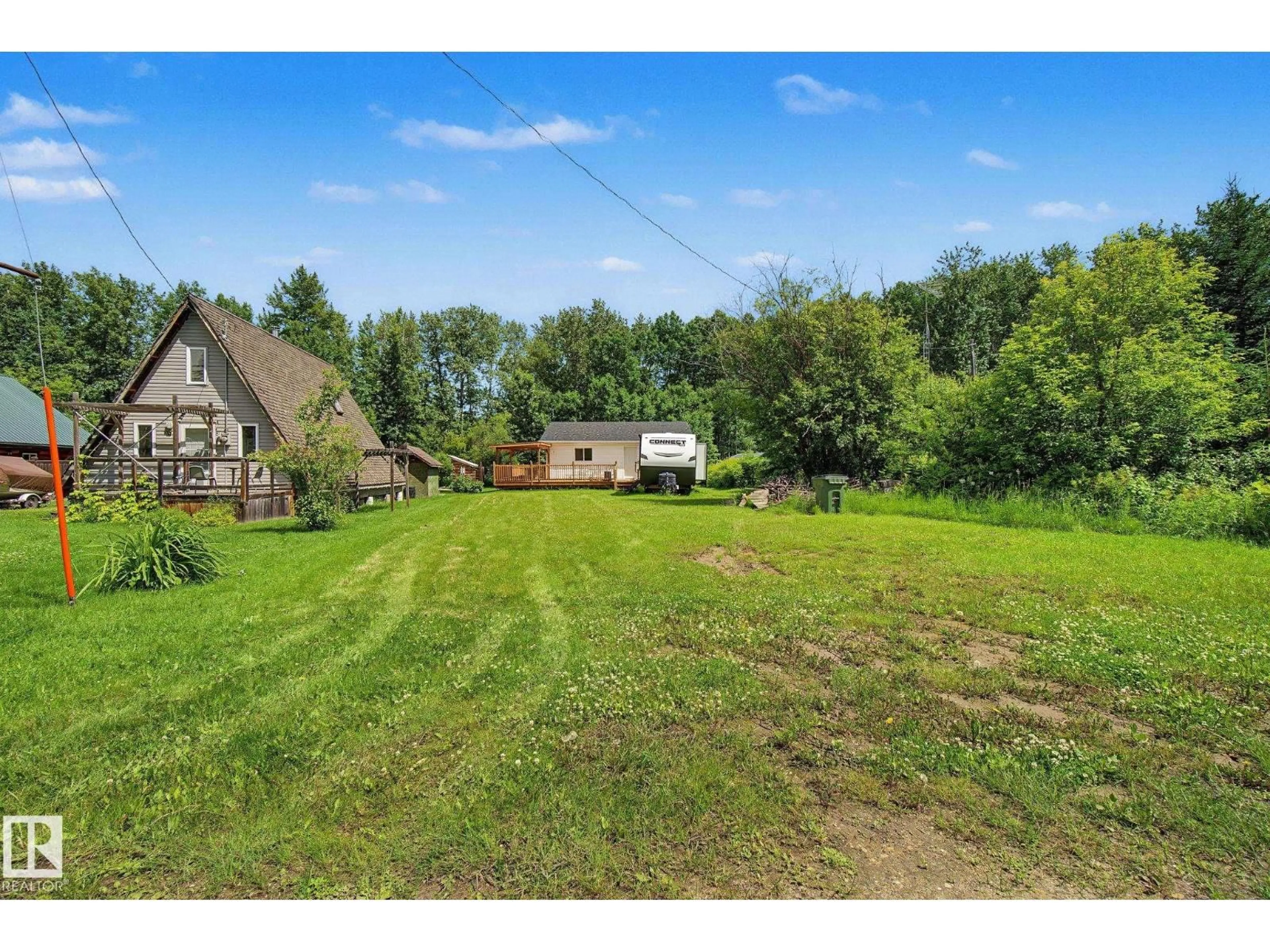 A pic from outside/outdoor area/front of a property/back of a property/a pic from drone, water/lake/river/ocean view for 21 SPRUCE CR, Rural Lac Ste. Anne County Alberta T0E0A0