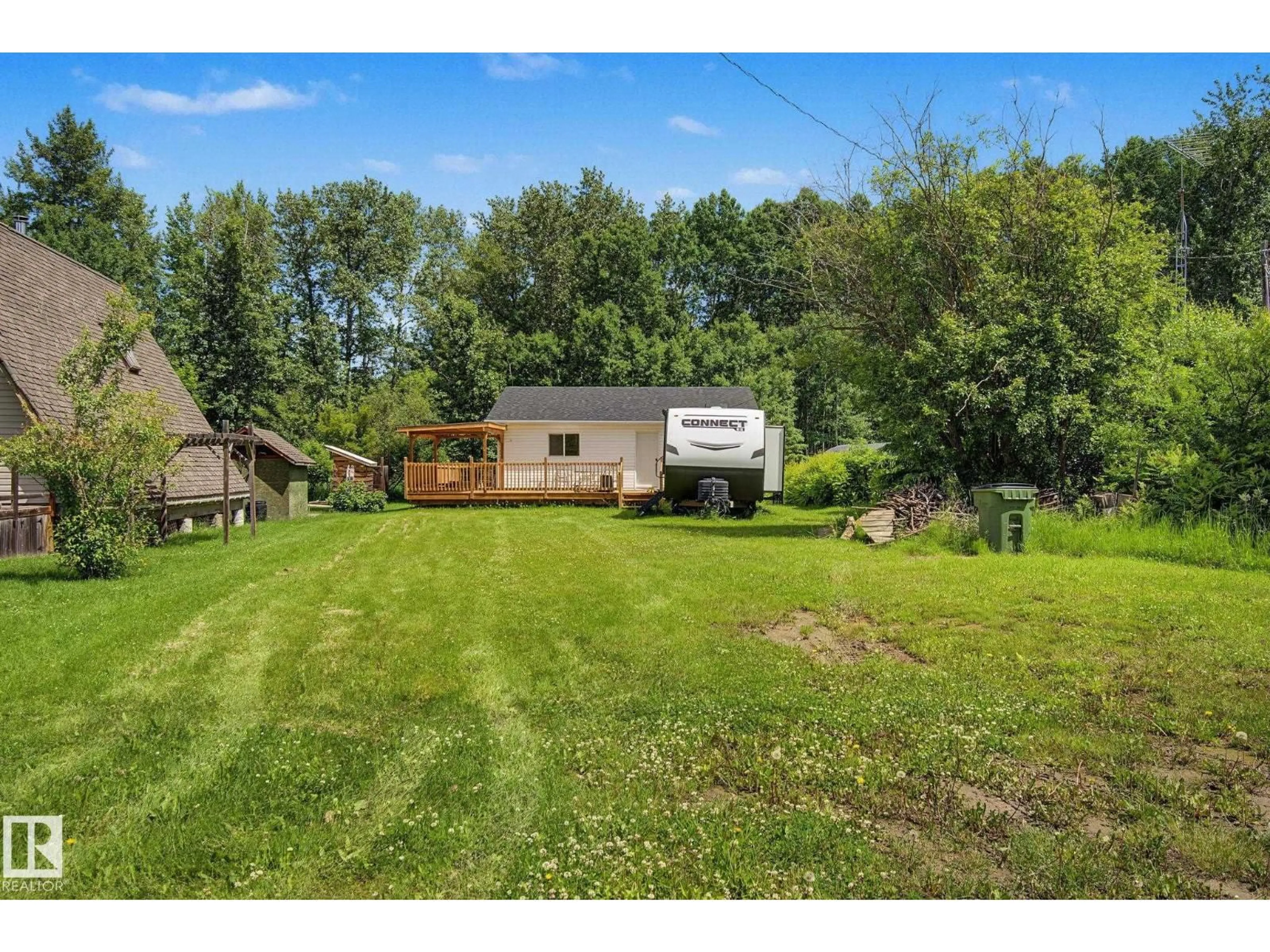 A pic from outside/outdoor area/front of a property/back of a property/a pic from drone, water/lake/river/ocean view for 21 SPRUCE CR, Rural Lac Ste. Anne County Alberta T0E0A0