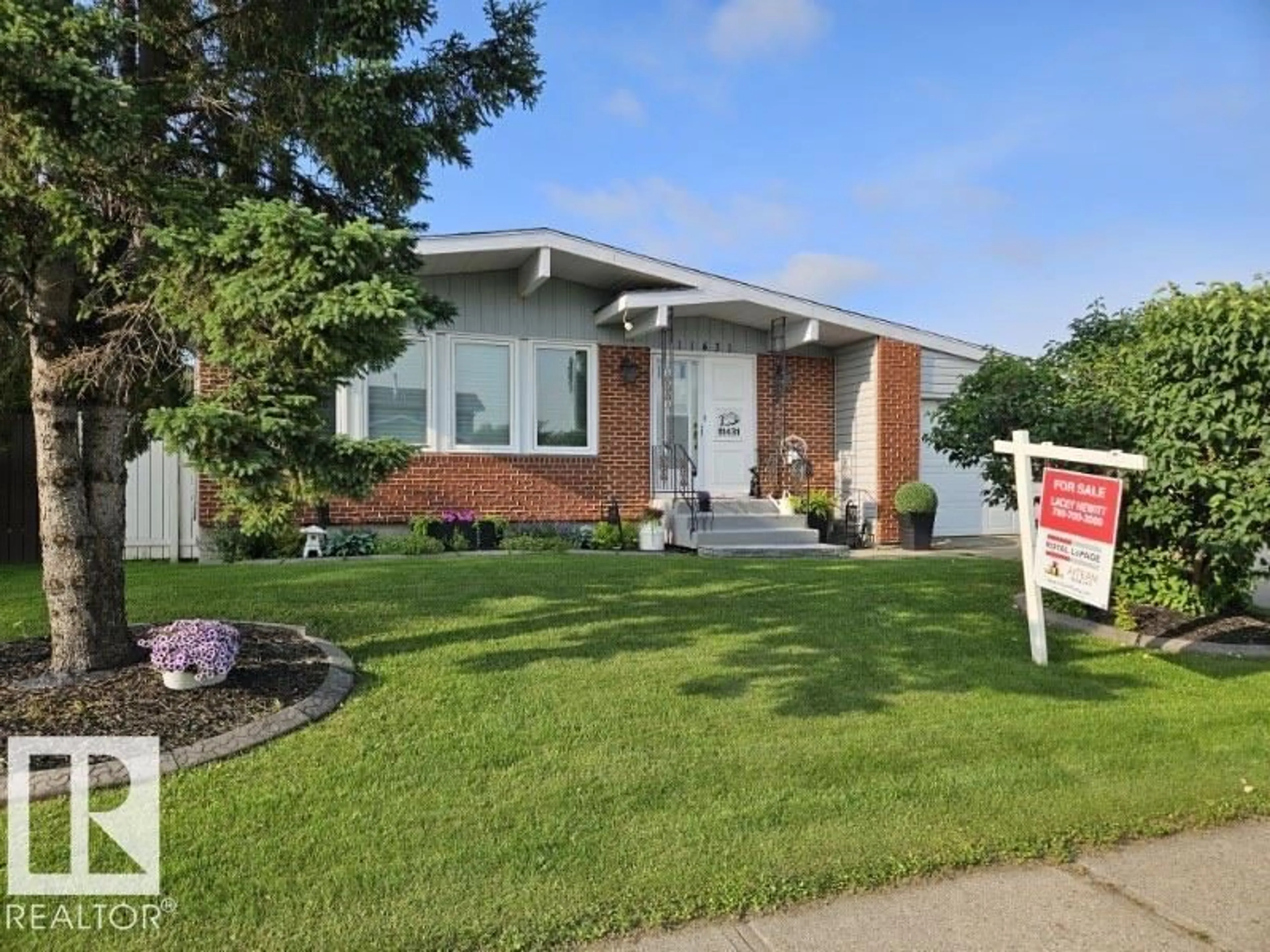 Home with vinyl exterior material, street for 11431 144 AV, Edmonton Alberta T5X1L7