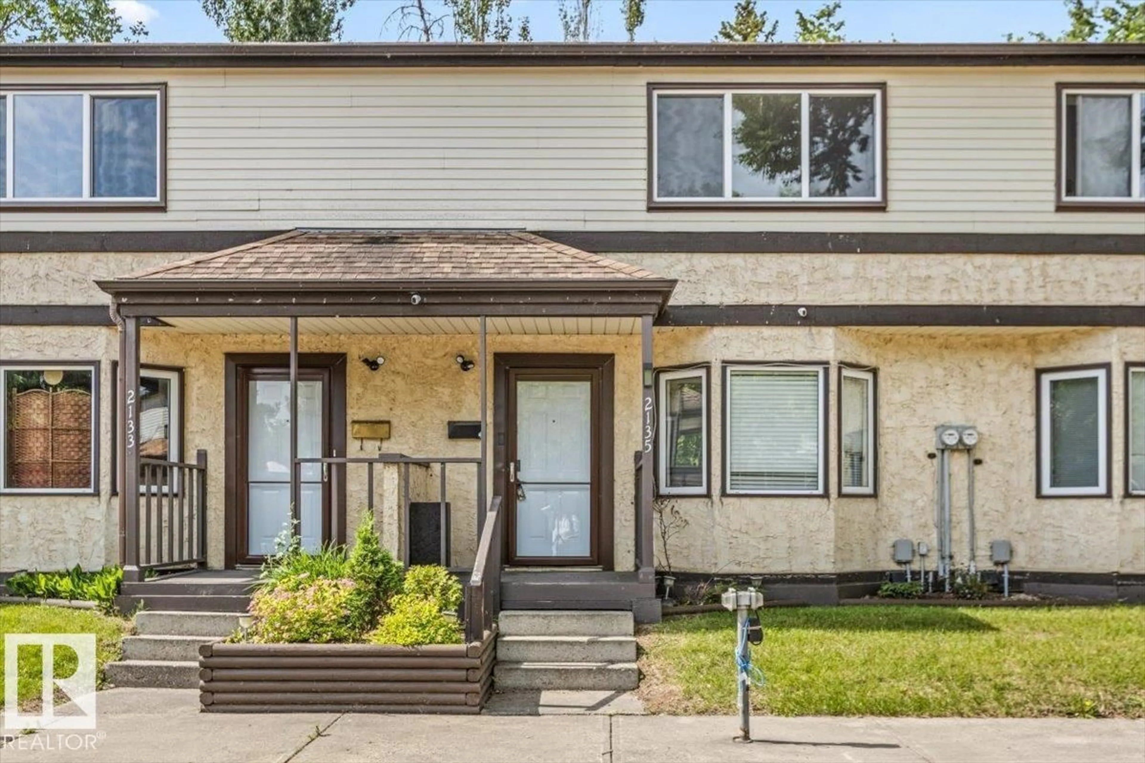 Home with vinyl exterior material, street for NW - 2135 141 AV, Edmonton Alberta T5Y1C4