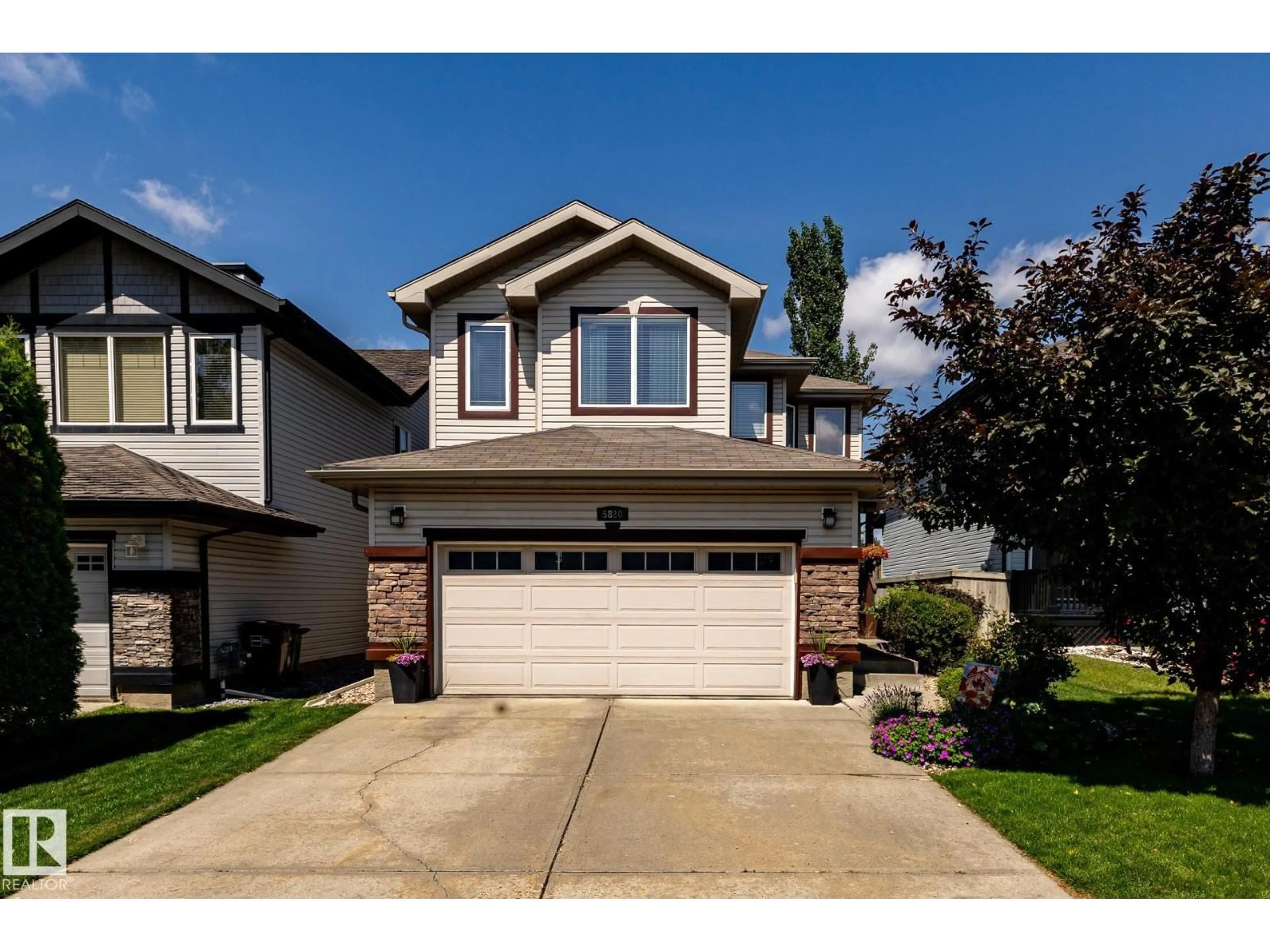 Home with vinyl exterior material, street for 5820 7 AV SW, Edmonton Alberta T6X0G6