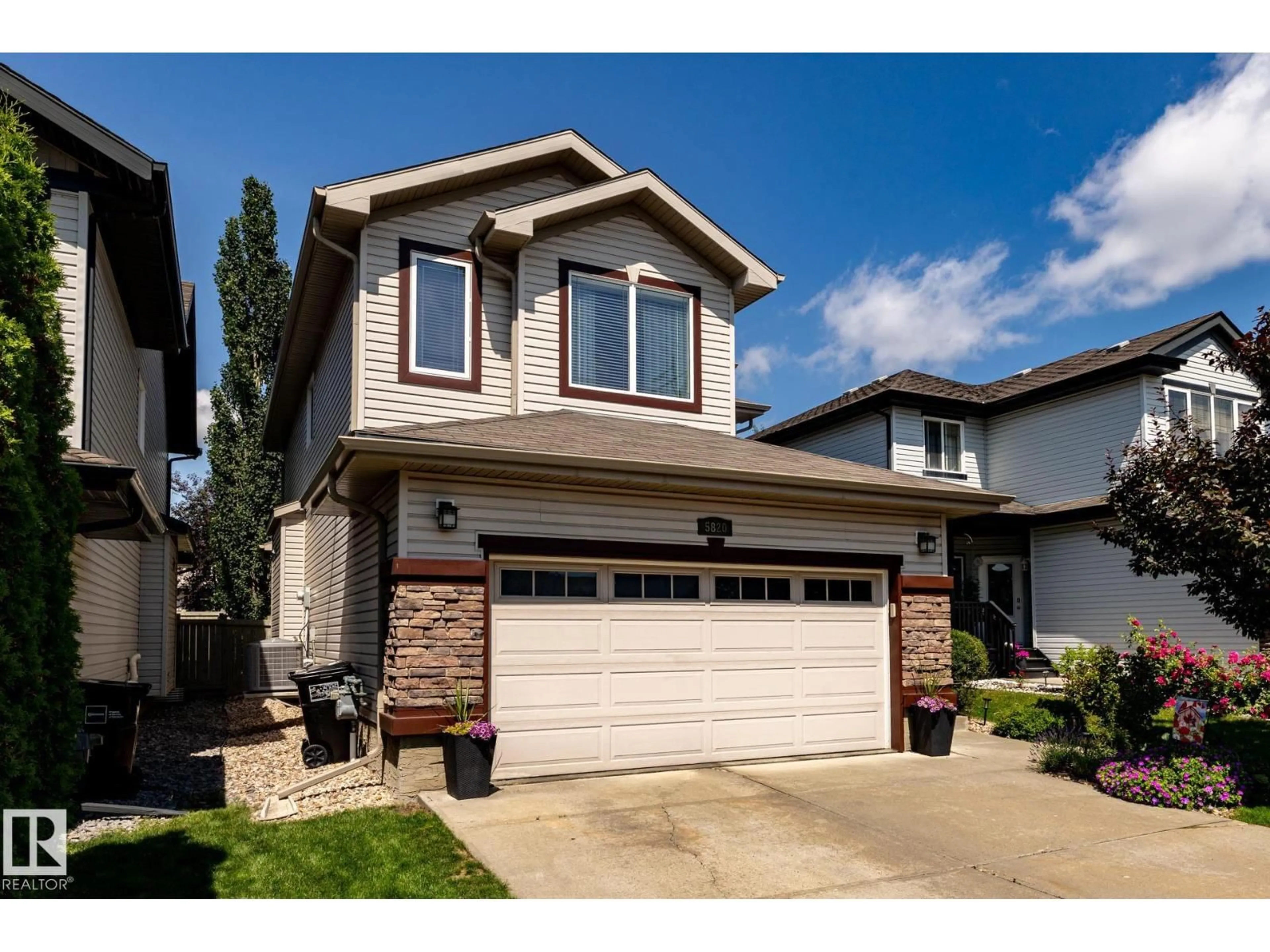 Home with vinyl exterior material, street for 5820 7 AV SW, Edmonton Alberta T6X0G6